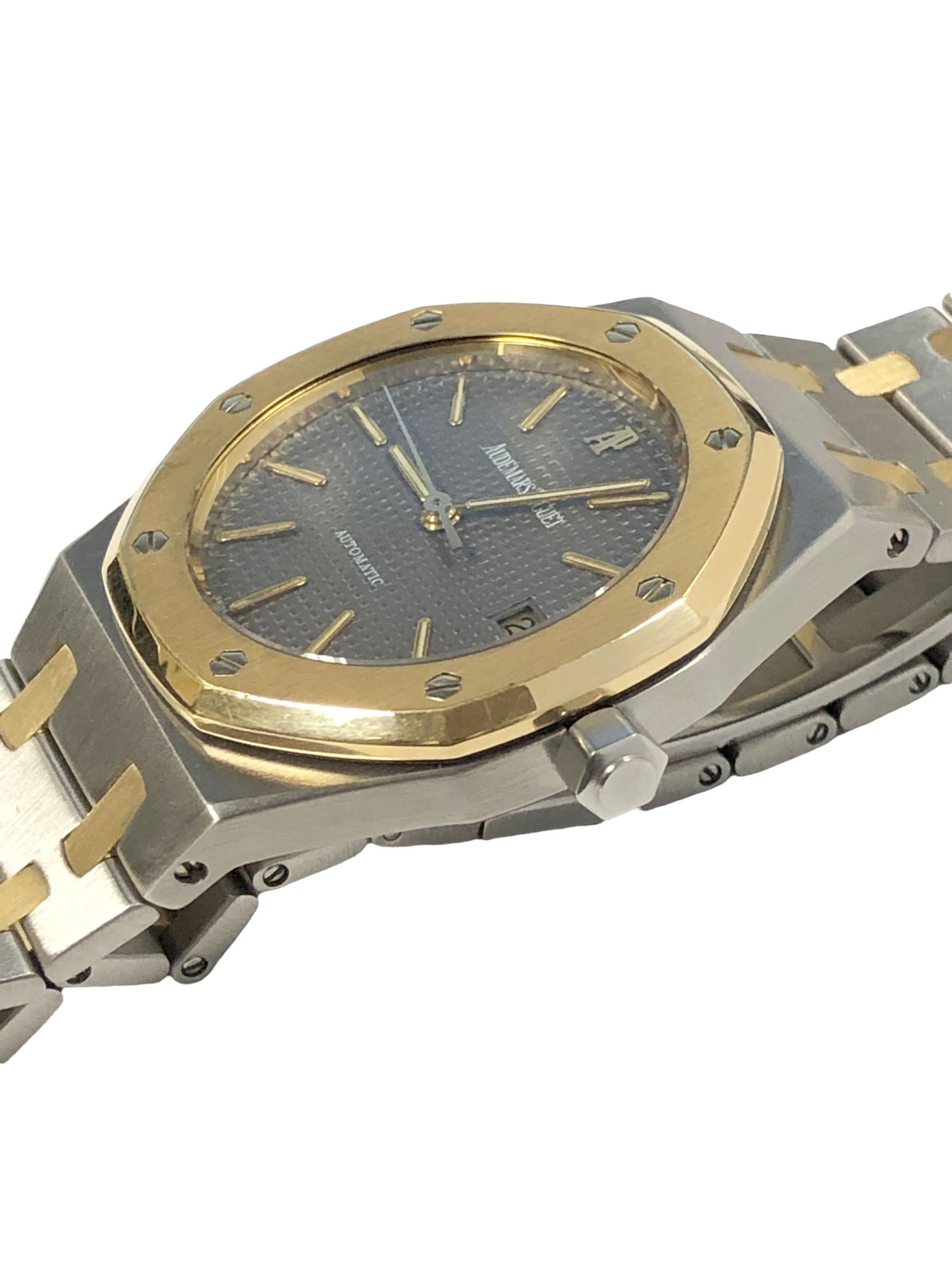 Circa 1990s Audemars Piguet Royal Oak Reference 1670 Wrist Watch, 37 M.M. Stainless Steel 3 piece case with 18k Yellow Gold bezel, caliber 2121 Automatic, self winding movement, charcoal Gray Waffle dial with raised Gold markers, sweep seconds hand