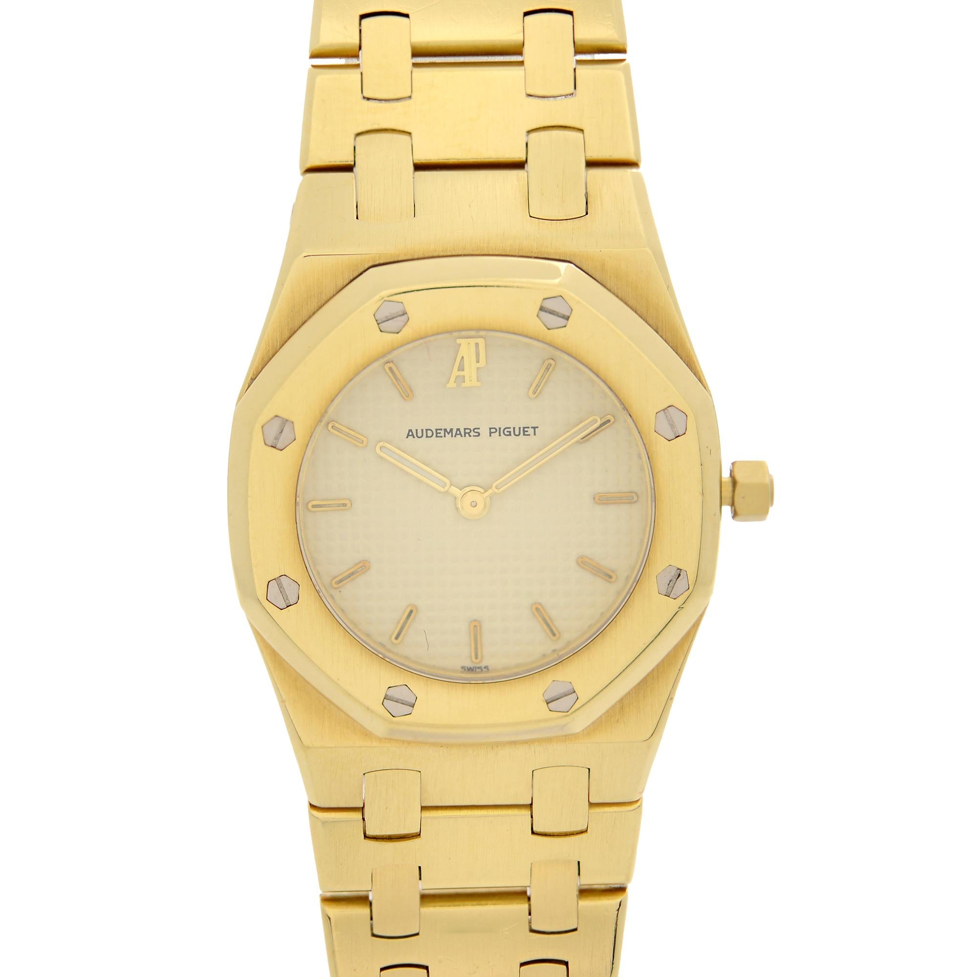 Pre-Owned Audemars Piguet Royal Oak 26 mm 18k Yellow Gold Cream Dial Ladies Quartz Watch 6007BA. The Was Produced in 1985. This Beautiful Timepiece is Powered by a Quartz Movement and Features: a Brushed 18k Yellow Gold Octagonal Case and Bracelet.