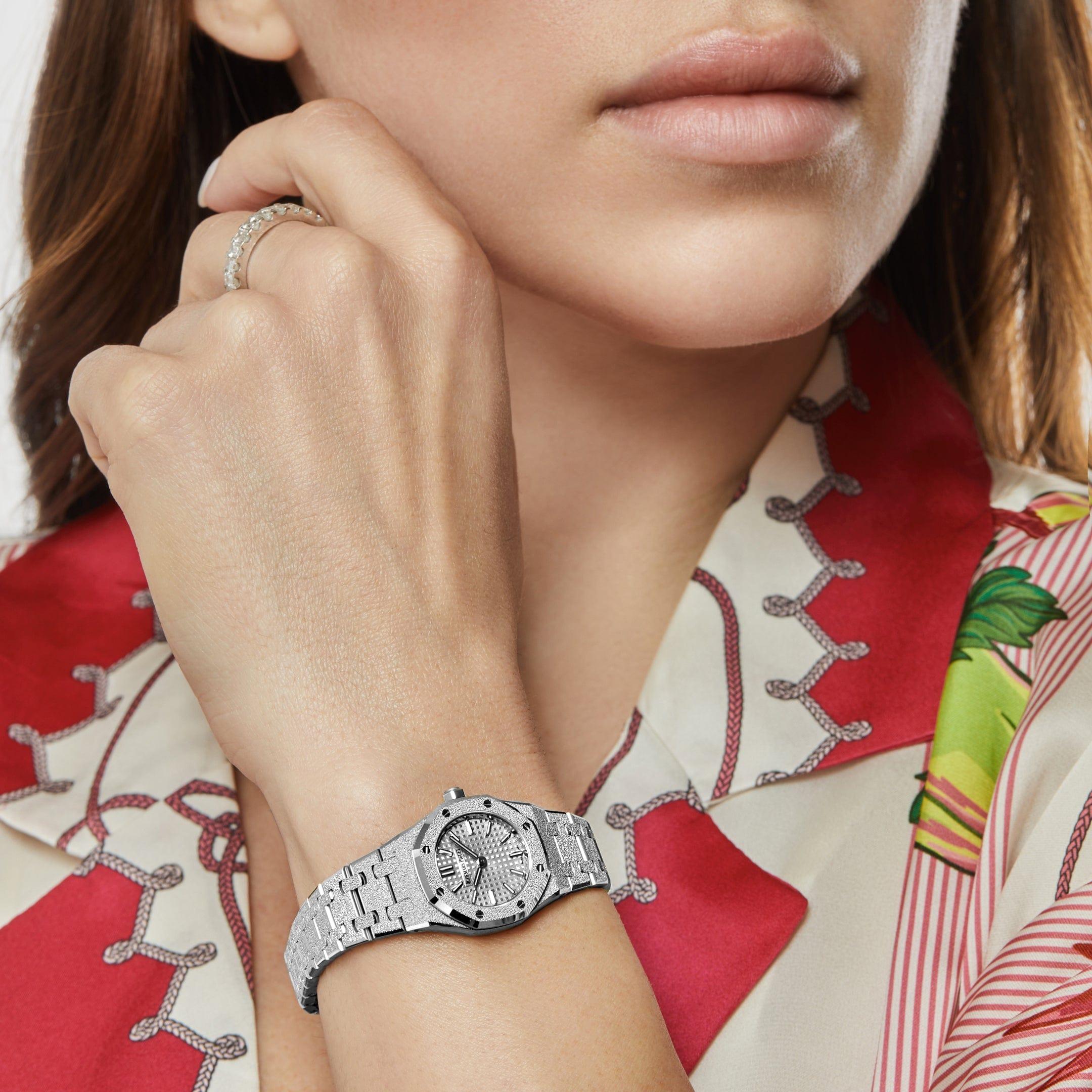 Jewels Aficionado offers the Audemars Piguet Royal Oak 67630BC.GG.1312BC.01-B ‘Mini’, a dazzling 23mm ladies’ timepiece crafted in frosted 18k white gold, featuring a shimmering hammered finish developed in collaboration with jeweler Carolina