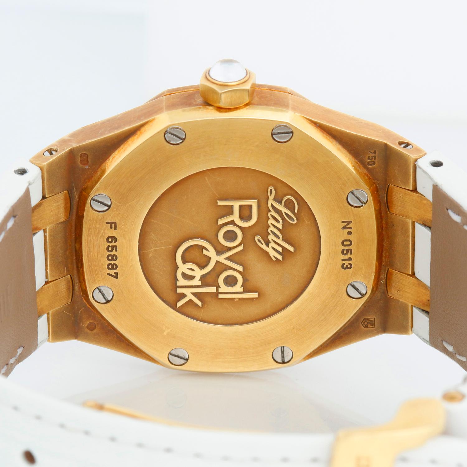 Audemars Piguet Royal Oak Ladies Quartz Watch Yellow Gold 67601BA - Quartz. Yellow Gold case (29mm diameter). Mother of Pearl dial with diamond hour markers. White Audemars Piguet strap with 18K Yellow gold deployant clasp. Pre-owned with custom box.