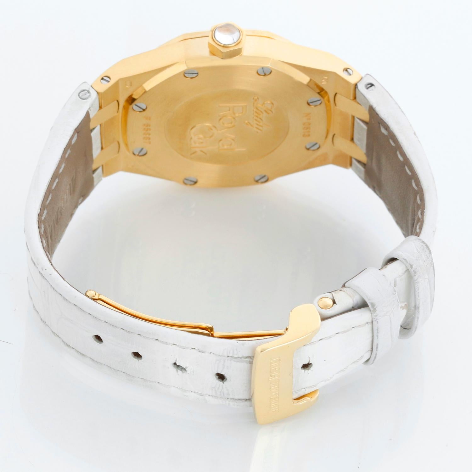 Audemars Piguet Royal Oak Ladies Quartz Watch Yellow Gold 67601BA - Quartz. Yellow Gold case (29mm diameter). Mother of Pearl dial with diamond hour markers. White Audemars Piguet strap with 18K Yellow gold deployant clasp. Pre-owned with custom box.