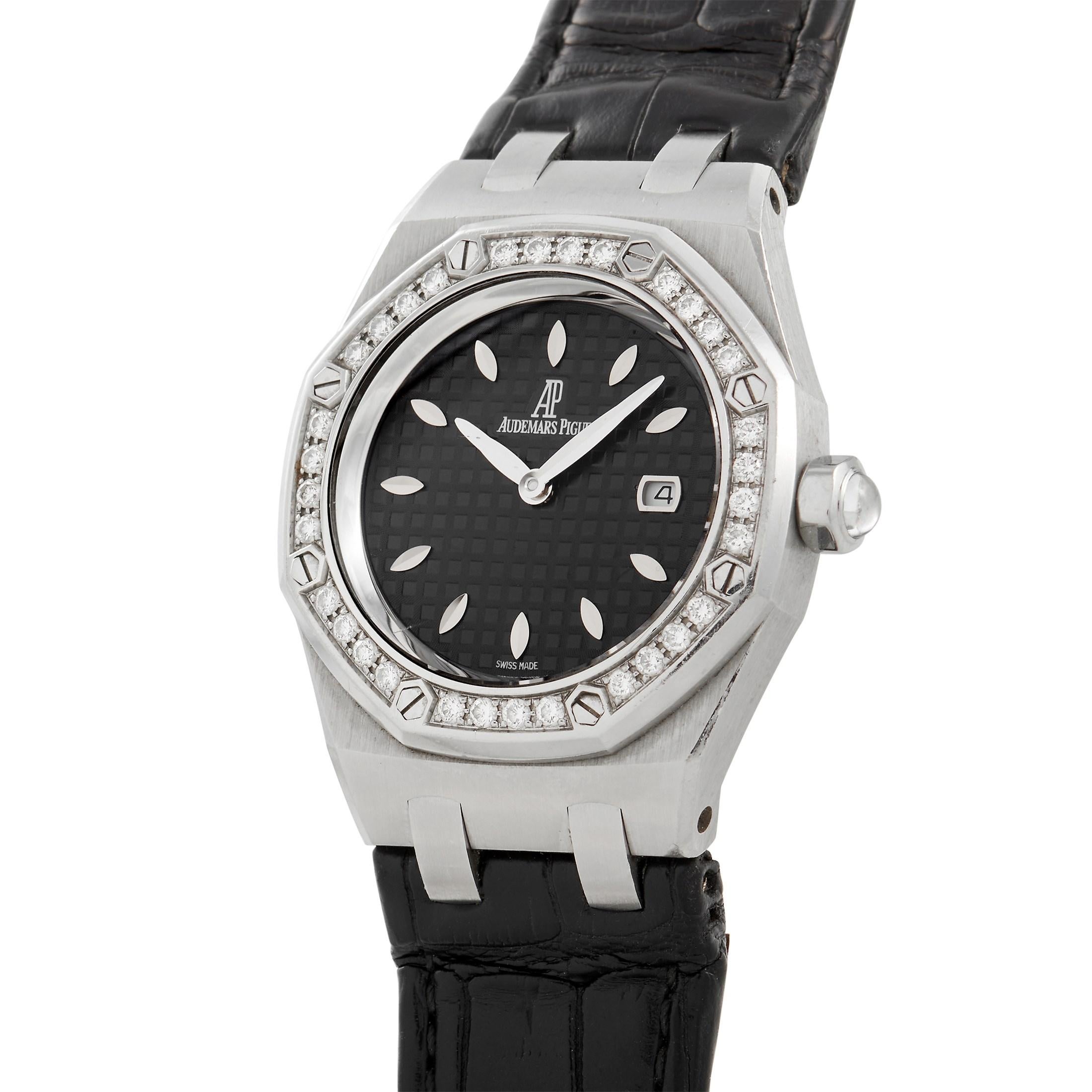 This Audemars Piguet Royal Oak Ladies Gem-set Quartz Steel watch features a 33mm stainless steel case, black waffle dial, diamond bezel featuring 32 (.65 ct.) diamonds, and a matte-finished black crocodile leather strap with a deployment buckle. The