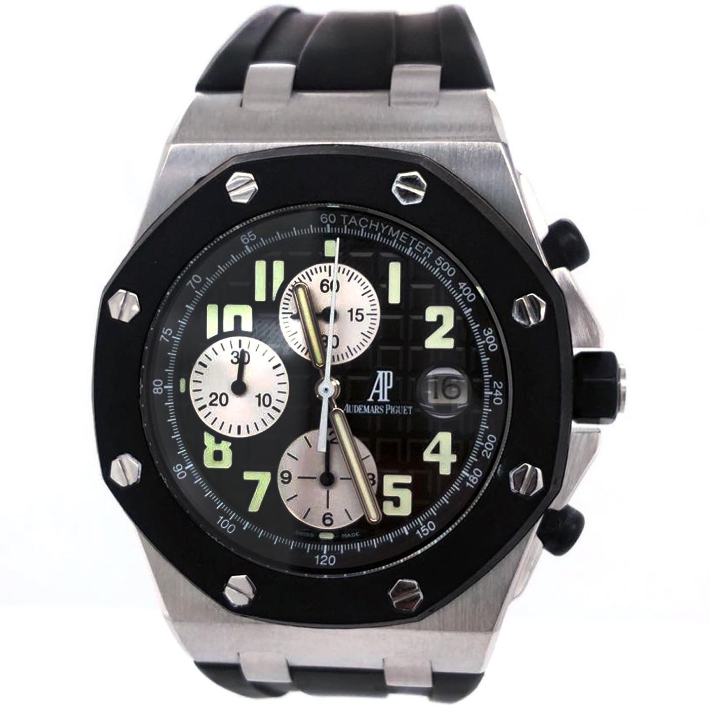 Stainless steel case with a black rubber strap. Fixed black rubber-clad bezel. Black waffle pattern dial with luminous hands and Arabic numeral hour markers. Minute markers. tachymeter around the outer rim. Dial Type: Analog. Luminescent hands and