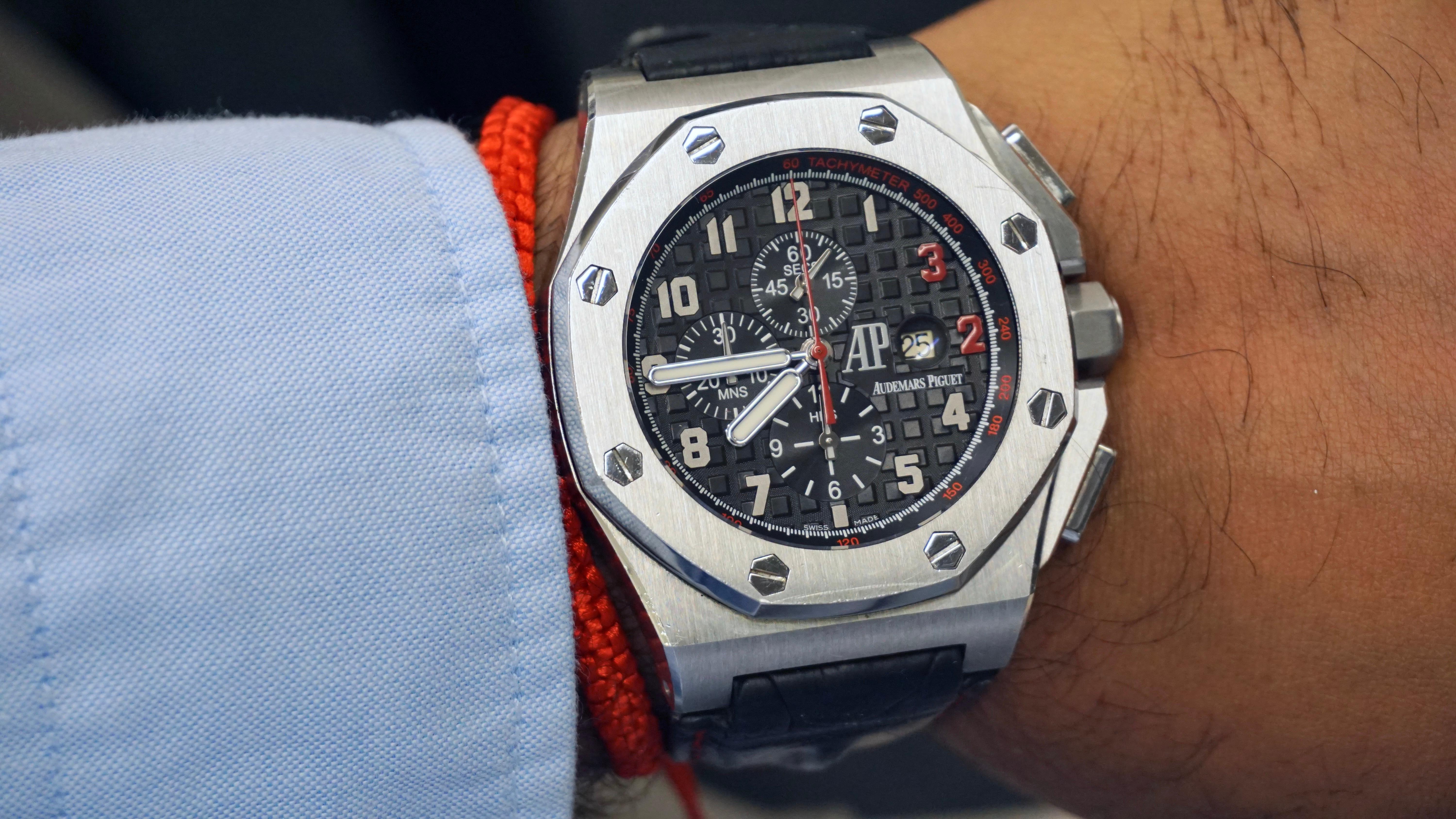 The Audemars Piguet Royal Oak Offshore Shaquille O'Neal 26133ST is a luxurious men's wristwatch featuring a black leather strap with a pin buckle closure. The watch case is made of stainless steel hexagonal shape and iconic screw design with a steel