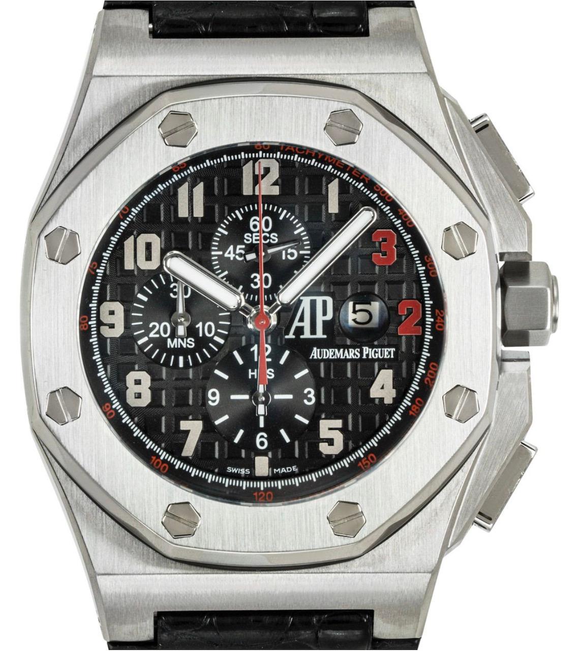 A limited edition 48mm Royal Oak Offshore Shaquille O'Neal wristwatch by Audemars Piguet. Featuring a black dial with arabic numbers, 3 & 2 are coloured in red to reflect the basketball players' jersey number. The watch further features a date