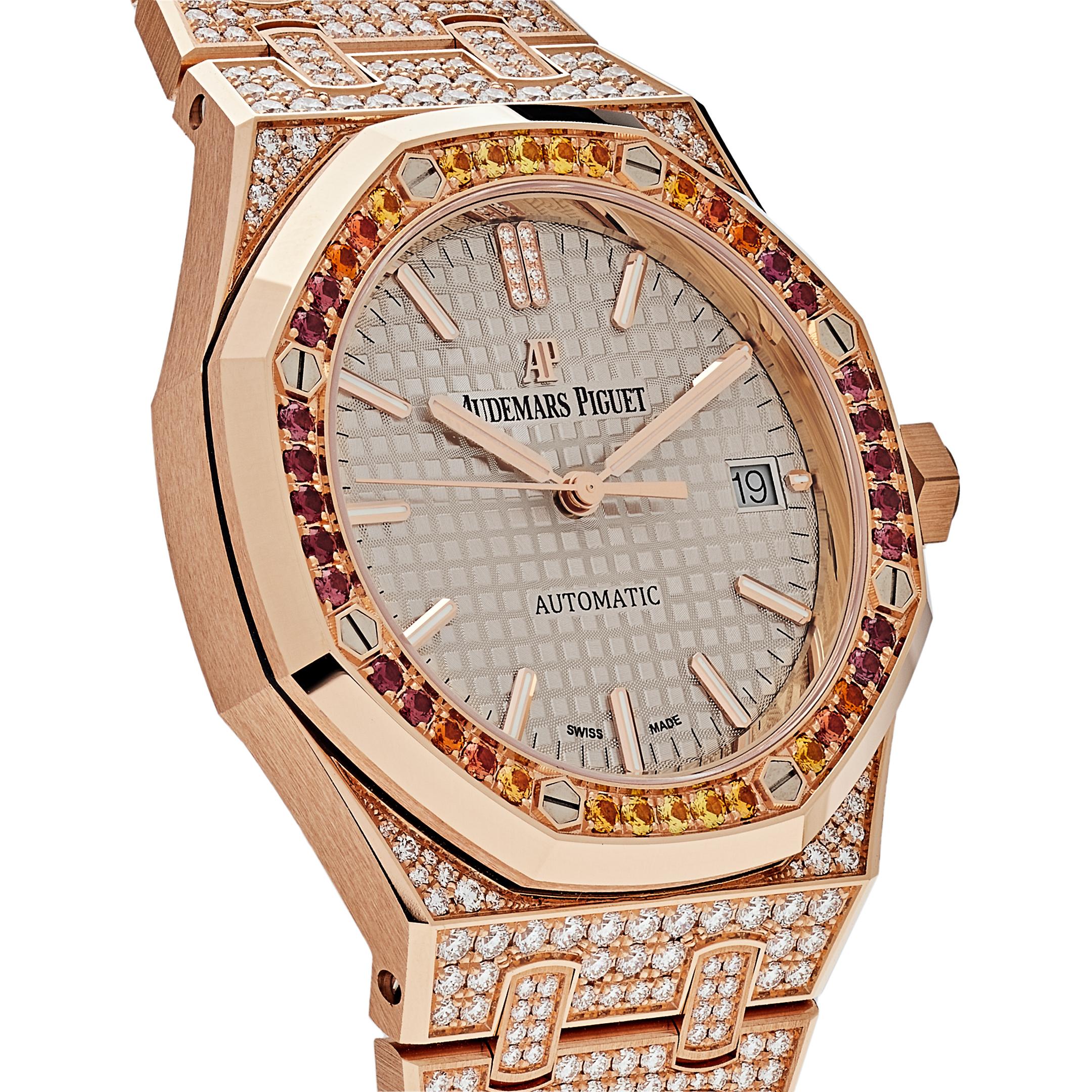 Introducing an impressive addition to Audemars Piguet's Royal Oak collection; The 18-carat pink gold 37mm case of this watch is paved with 124 brilliant-cut diamonds, while the bezel adorns 40 yellow sapphires, red garnets and orange spessartite