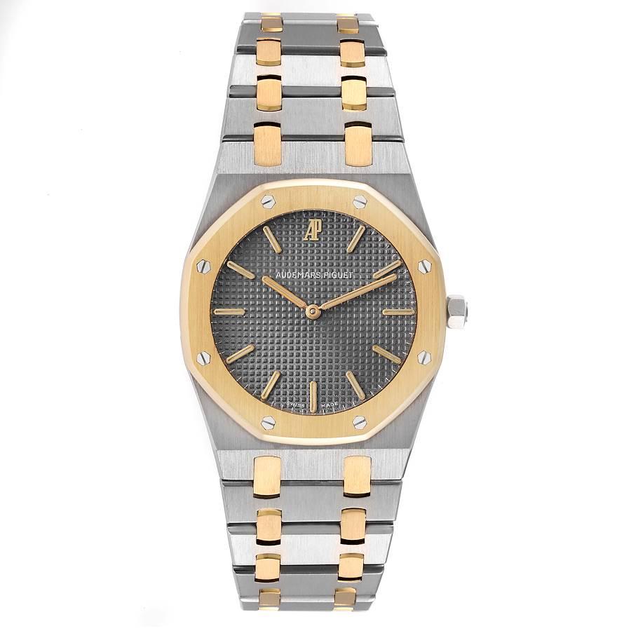 Audemars Piguet Royal Oak Steel Yellow Gold Mens Watch 56303SA. Quartz movement. Stainless steel case 33.0 mm in diameter. 18k yellow gold bezel punctuated with 8 signature screws. Scratch resistant sapphire crystal. Grey Tapisserie (waffle pattern)