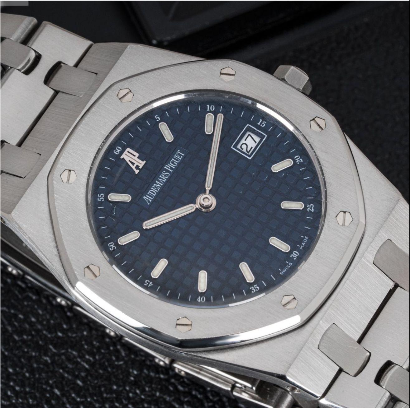 A 33mm stainless steel Royal Oak Ultra Thin by Audemars Piguet. Featuring a blue dial with grande tapisserie pattern, a date aperture and a steel bezel set with the 8-screw design. Fitted with a sapphire crystal, a quartz movement and a stainless