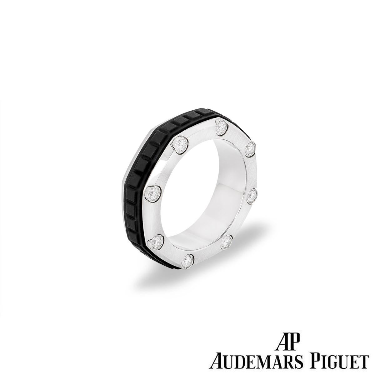 A titanium diamond set ring from the Audemars Piguet Royal Oak Offshore collection. The ring is of an octagonal design set through the middle with a patterned rubber inlay. The outer edges both have a satin finish with one side set with 7 round