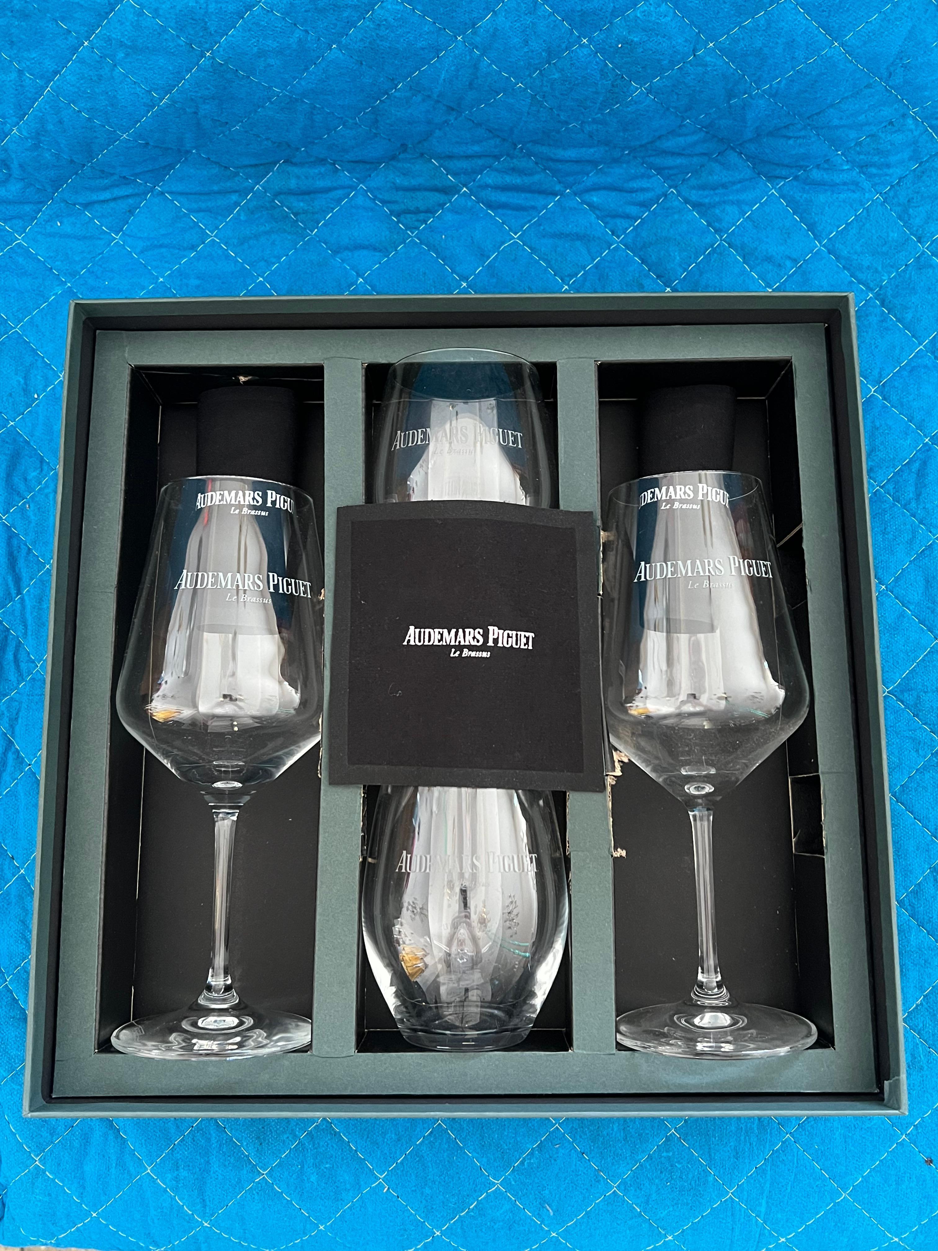 A boxed set-unused. Two wine glasses and two water glasses probably given out as VIP gifts by Audemars Piguet. All glasses and box marked.