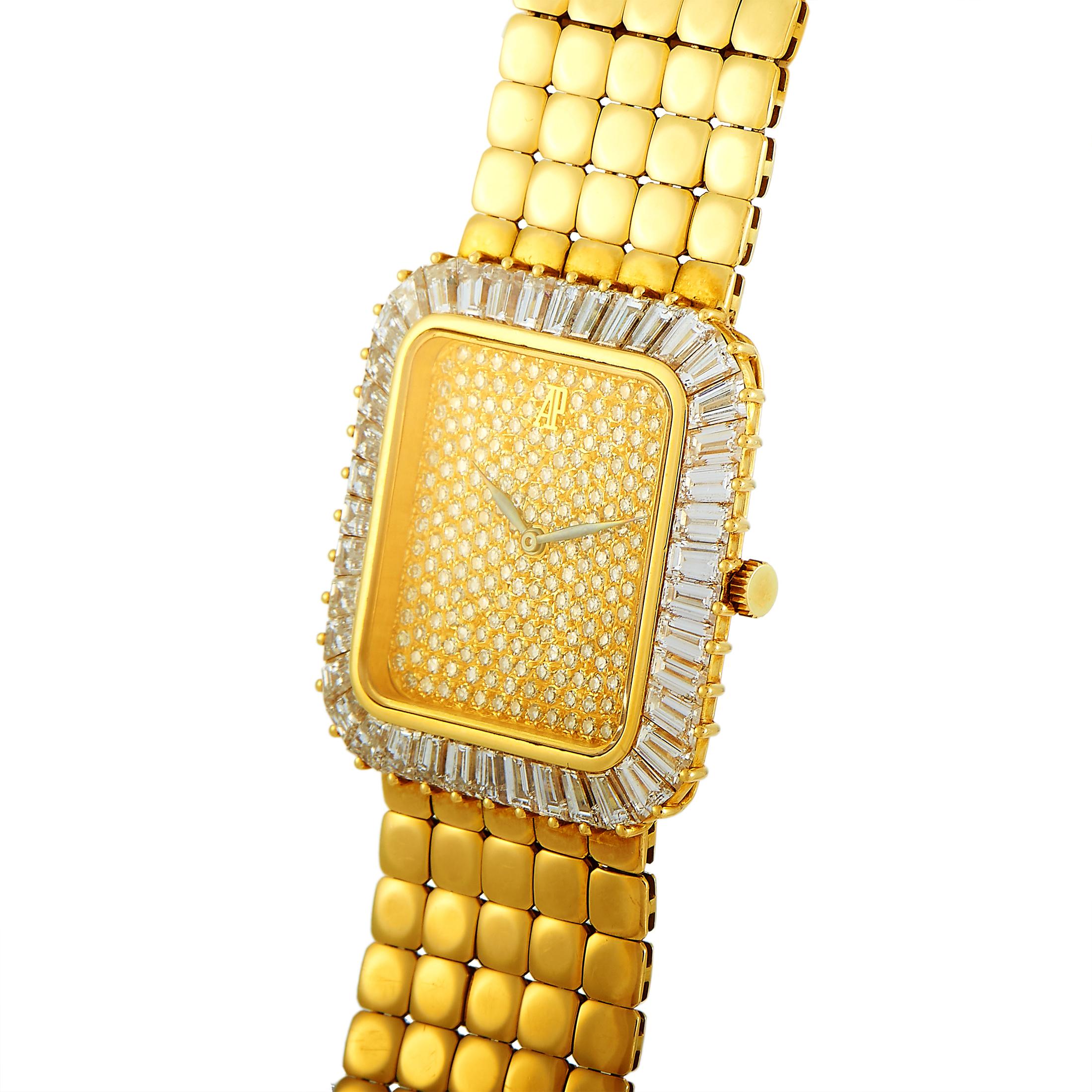 This Audemars Piguet vintage timepiece comes with an 18K yellow gold case embellished with baguette diamonds set on the bezel. The case is presented on an 18K yellow gold bracelet. The dial is paved with diamonds and features central hours and