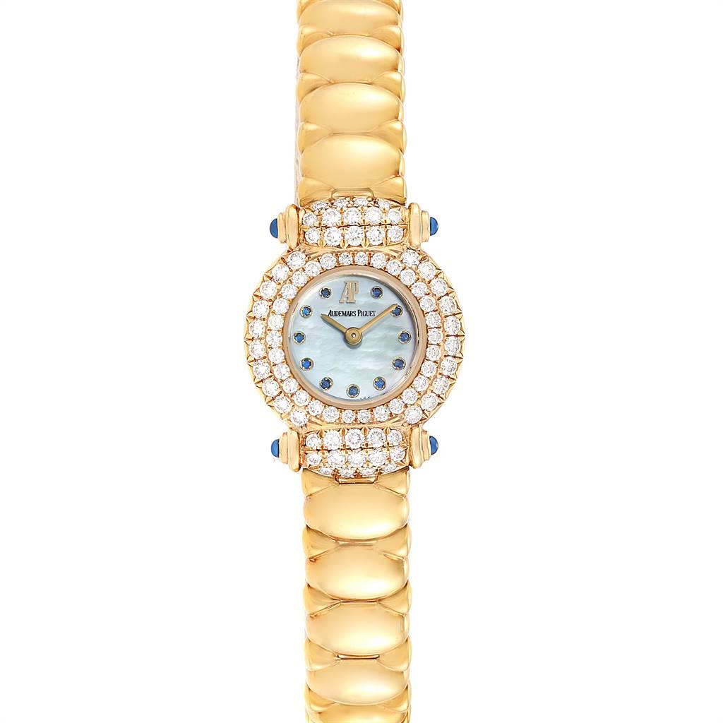 Audemars Piguet Yellow Gold MOP Diamond Sapphire Ladies Watch. Quartz movement. 18k yellow gold round case 21.2mm X 25.5mm. 18k yellow gold diamond bezel. Scratch resistant sapphire crystal. Flat profile. Blue mother of pearl dial with sapphires