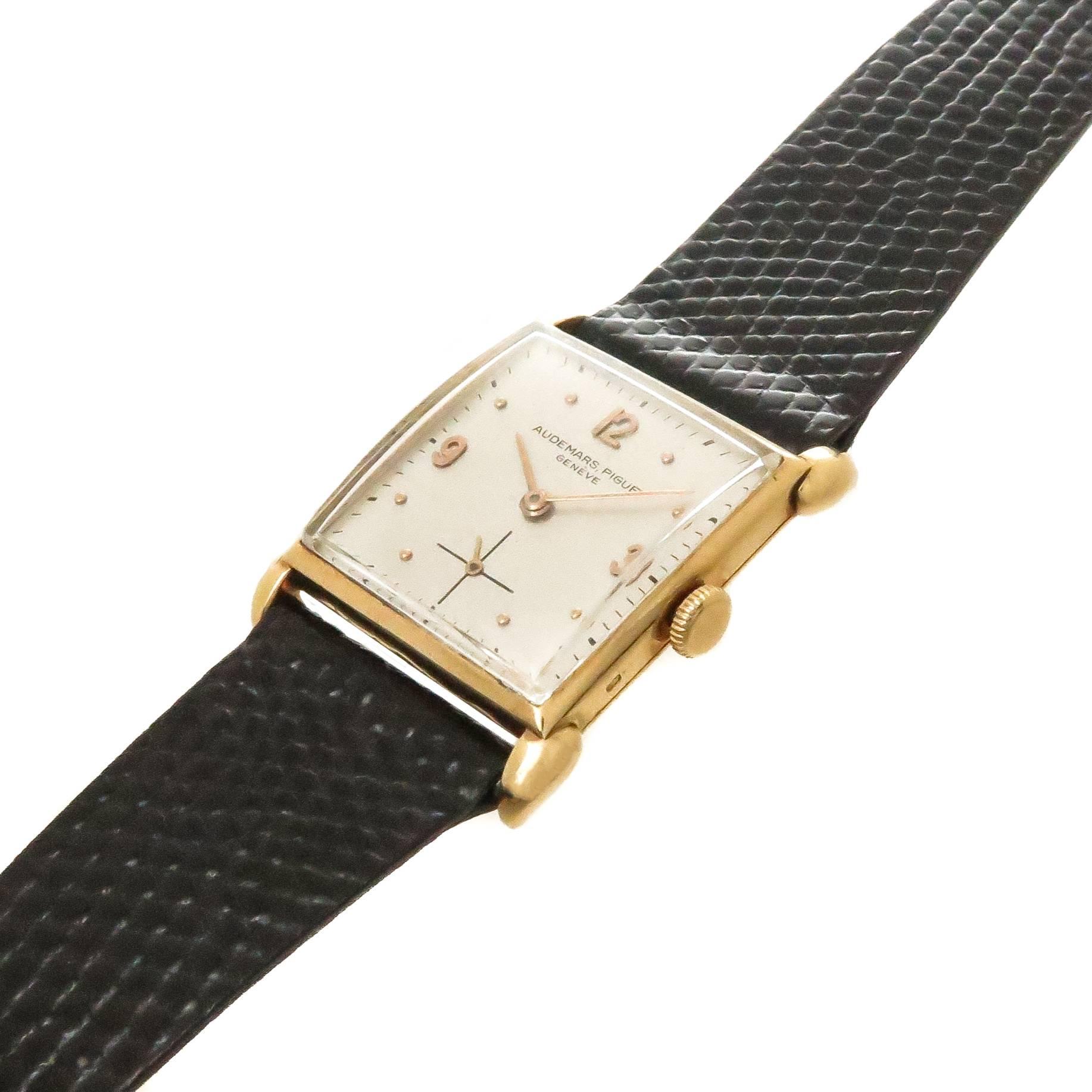 Circa 1940s Audemars Piguet Wrist watch, 33 X 25 MM 18K Yellow Gold Case with Flared lugs. 18 Jewel Mechanical, manual wind movement. Recently restored as original silver dial with Raised gold Markers.  New Black Lizard strap. Watch measures 8 1/4