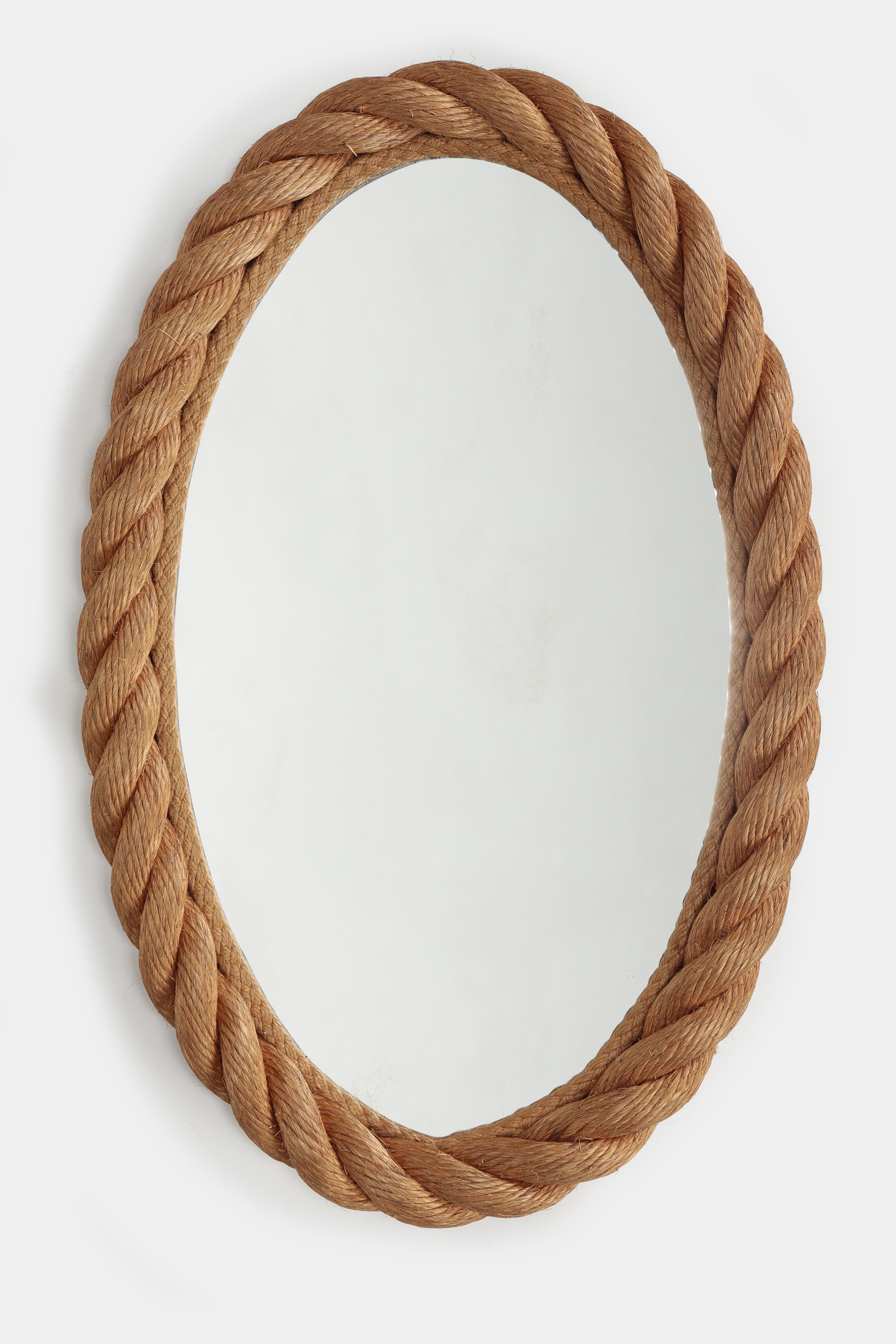 Adrien and Audoux wall mirror manufactured in the 1950s in France. Oval mirror glass surrounded by a braided rope.