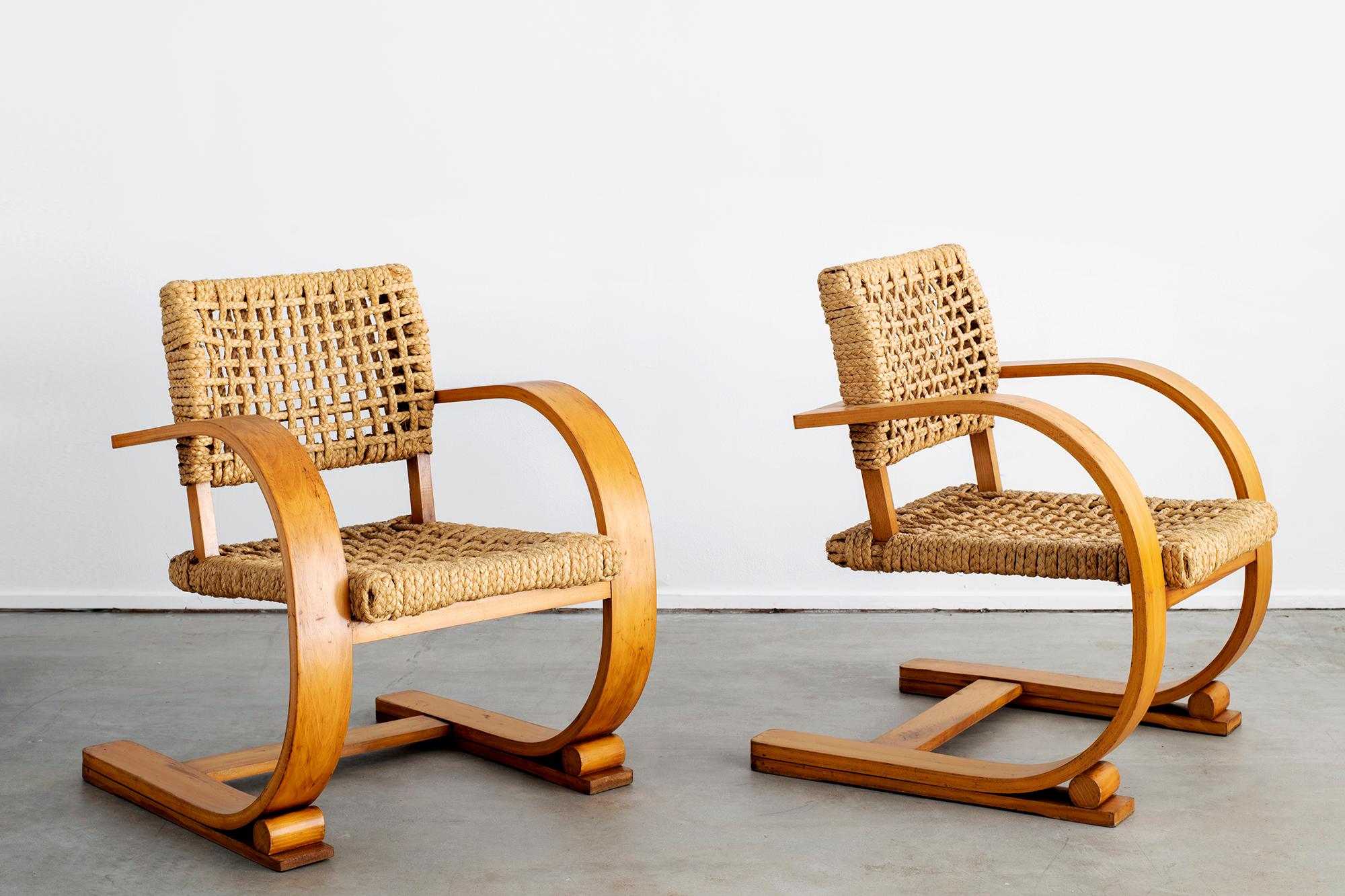 Amazing pair of chairs by Paris designer - Adrien Audoux & Frida Minet.
Classic modern French design with rope seats and backs
Wide French bent oakwood arms with fantastic patina.

Matching table available - sold separately. 

 