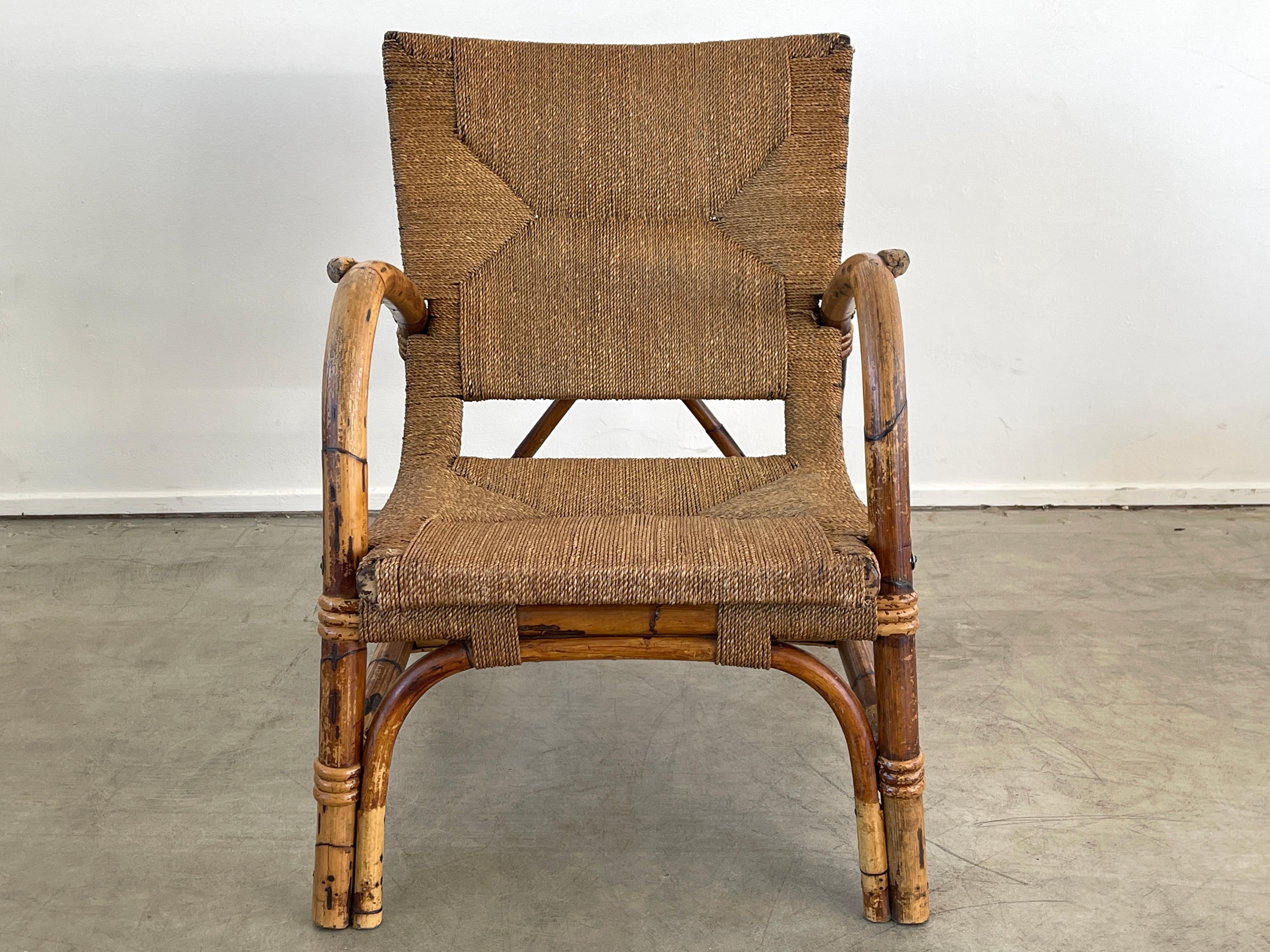 Wonderful armchair attributed to Audoux Minet in bamboo and rope. 
Great curved shape and fantastic patina to rope and bamboo.