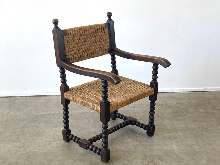 Audoux Minet attributed armchair with wonderful dark patina and design
Carved ball frame with woven seat and back.
