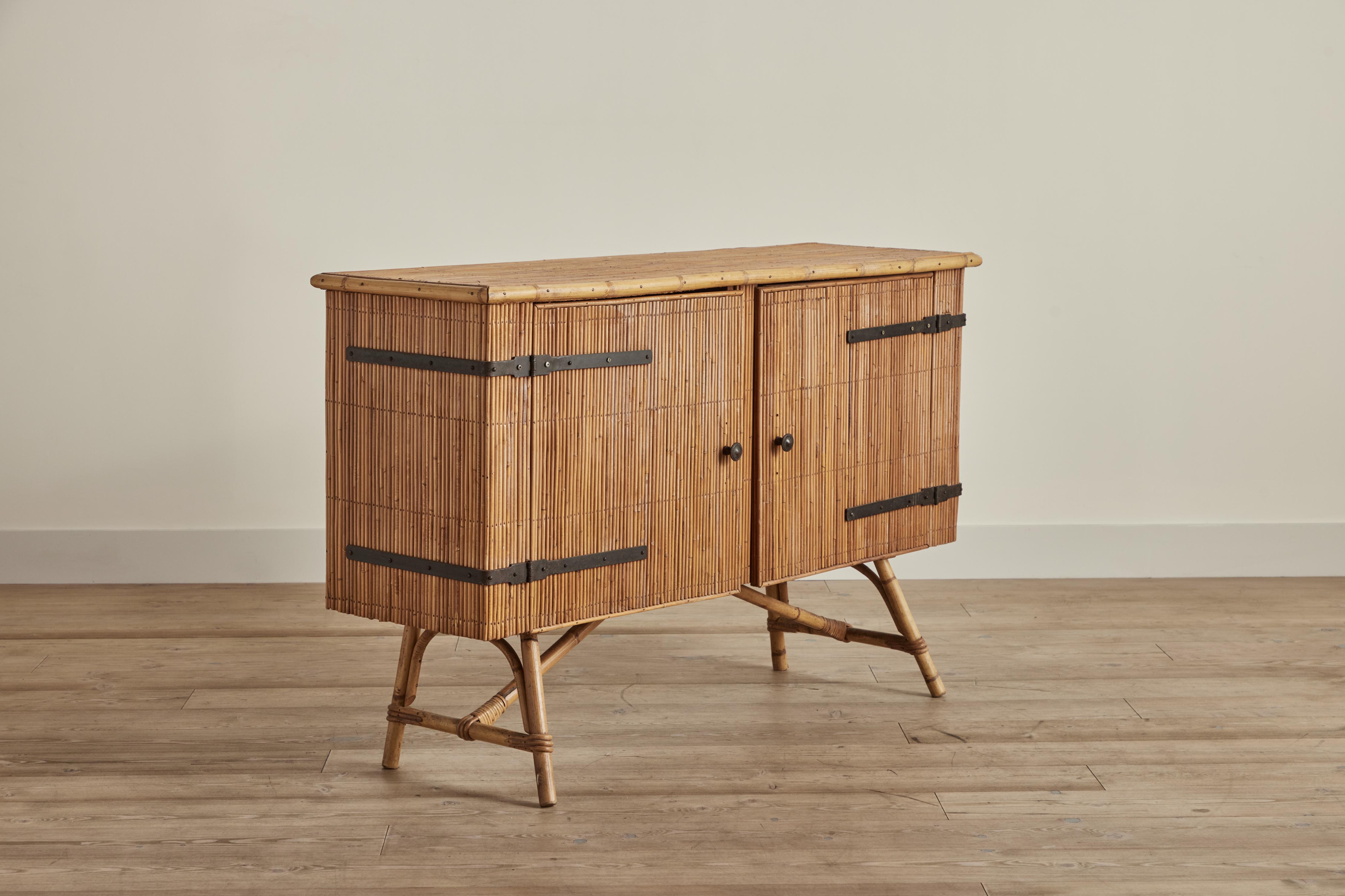 Small bamboo and iron hardware sideboard attributed by Adrien Audoux and Frida Minet, France circa 1950. Sideboard is good condition with some wear on bamboo and wood interior that is consistent with age and use. 
