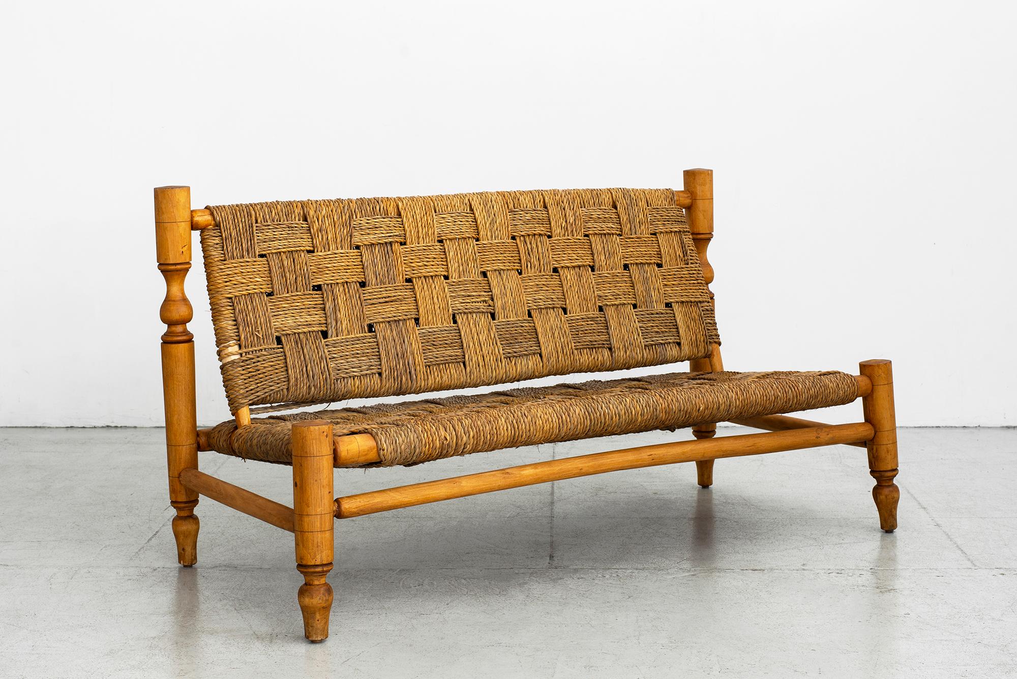 Audoux Minet bench with woven rope seat and back.
Signature carved wood legs and detailing.
Wonderful patina.

 