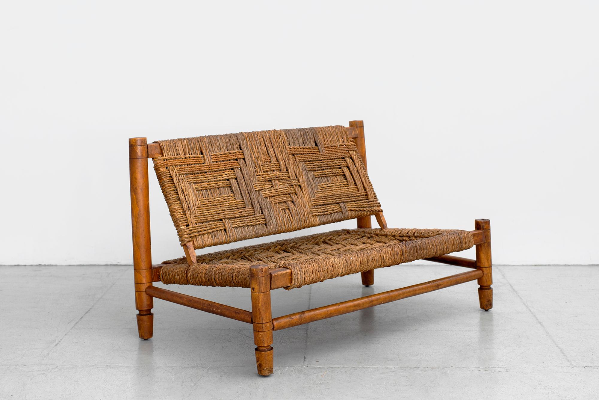 Audoux Minet bench with woven rope seat and back.
Signature carved wood legs and detailing.
Wonderful patina.



   