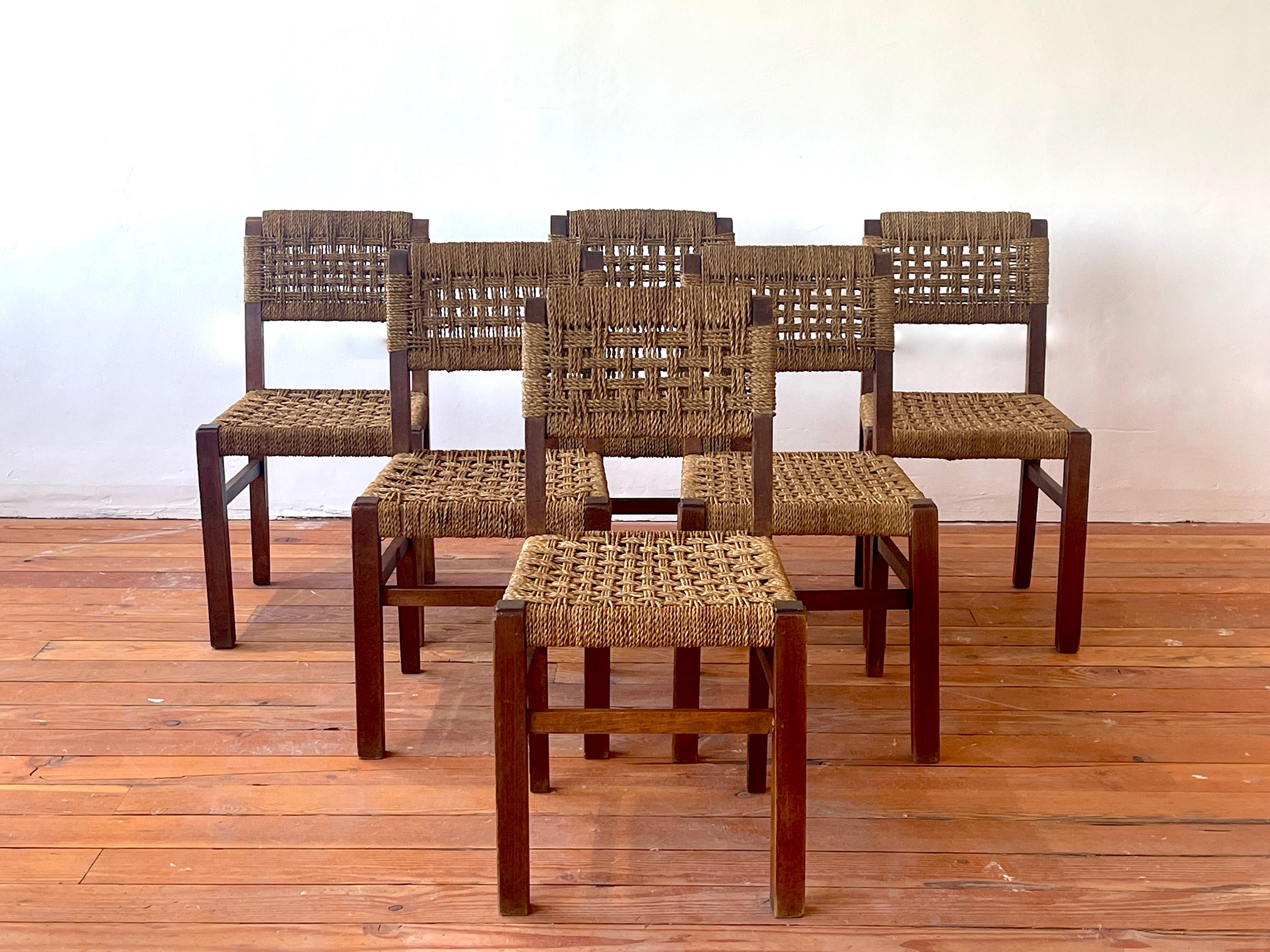 Incredible set of 6 Adrien Audoux & Frida Minet dining chairs, France, circa 1950s.

Signature woven rope seats and backs with oak wood in wonderful original patina. 


