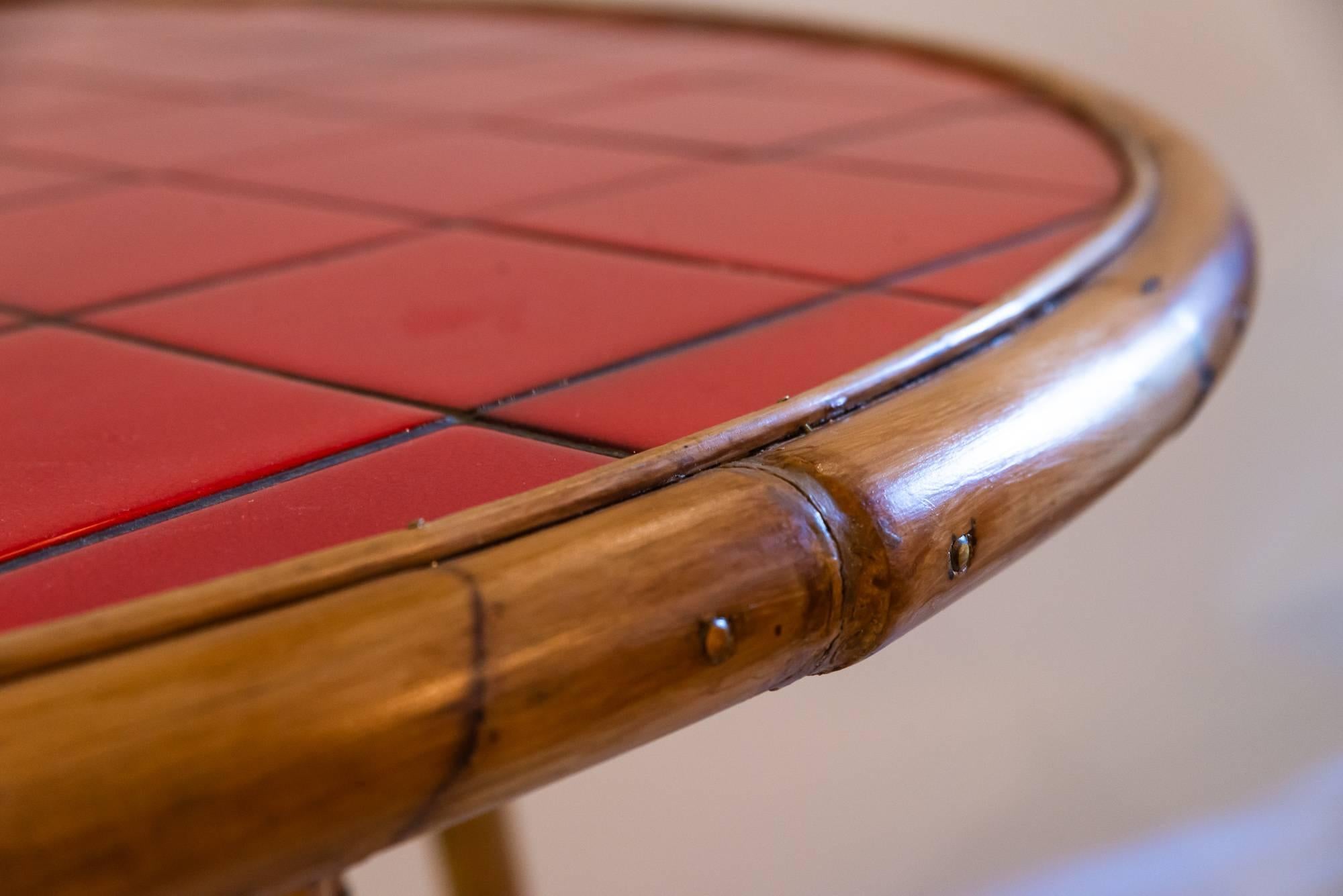 Audoux-Minet, dining table,
bamboo and red ceramic,
Vallauris
circa 1960, France.
Measures: Height 70 cm, diameter 1m40.