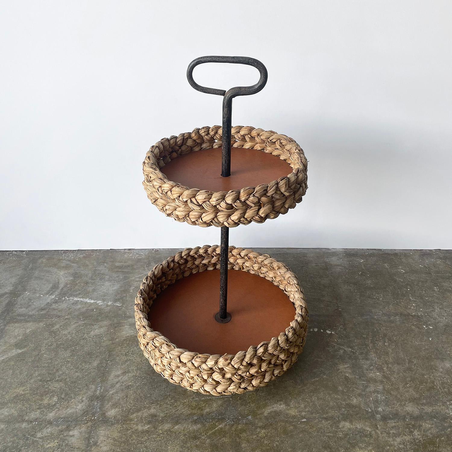 Adrien Audoux & Frida Minet cart
France, circa 1950’s
Multi use tiered storage or service cart on casters
Framed in oversized braided jute
Lined with original leatherette
Aged iron post and handle
Wonderful patina throughout

Overall: 28.75”