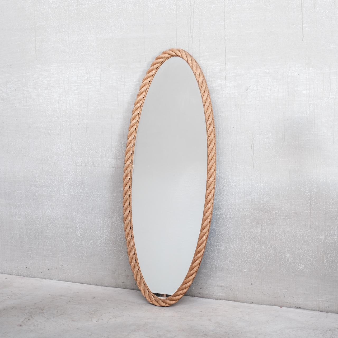 A large oval mirror by Audoux-Minet.

Rope and glass.

France, circa 1960s.

The largest model produced it is believed.

Good vintage condition.

Dimensions: 152 H x 59 W x 5 D in cm.

Delivery: POA.


