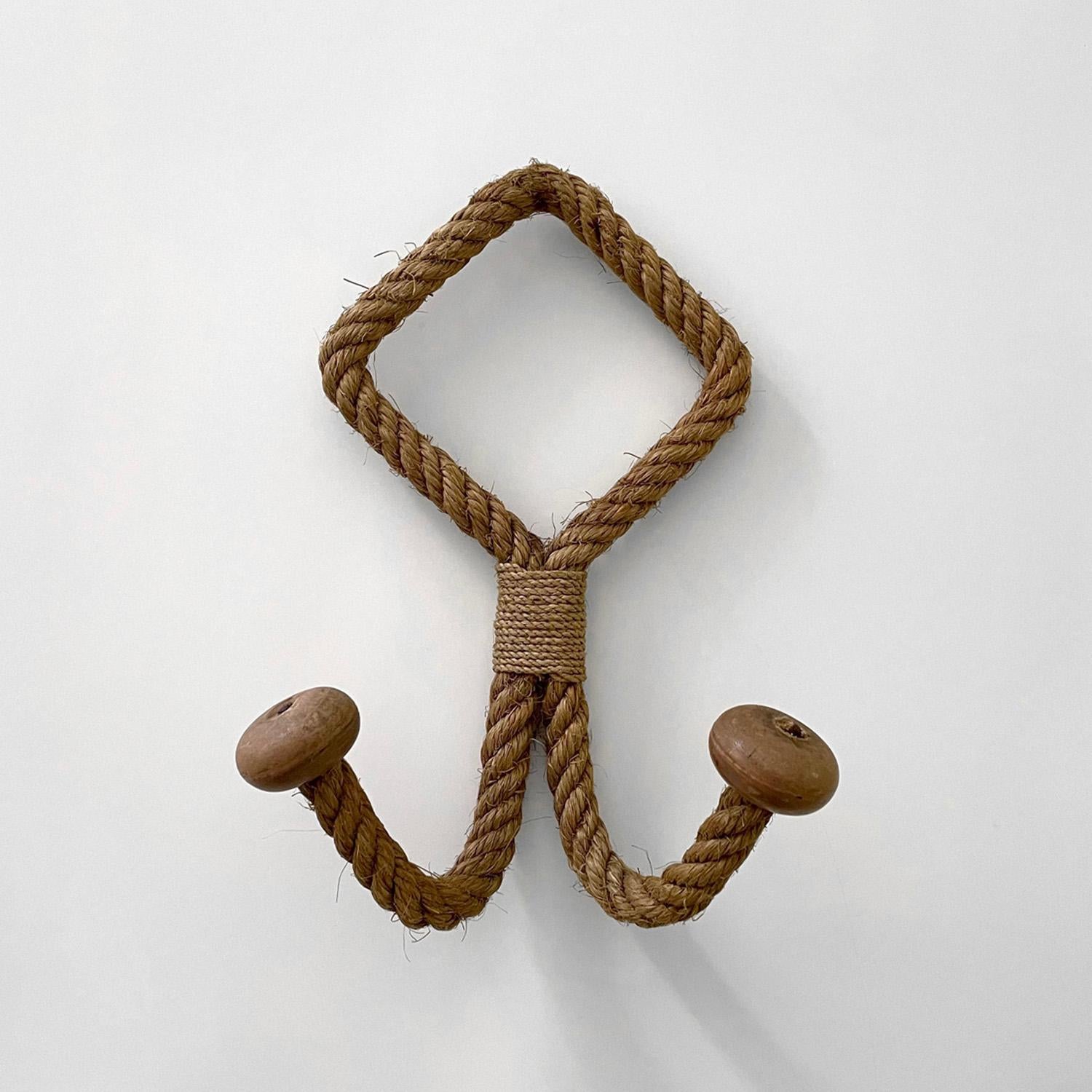 Adrien Audoux & Frida Minet French rope double wall hook coat rack 
France, circa 1950’s
Wall mounted sculpted rope frame with two upturned arch hooks 
Both hooks are finished with rounded pegs
Well worn patina from years of love and use
Last photo