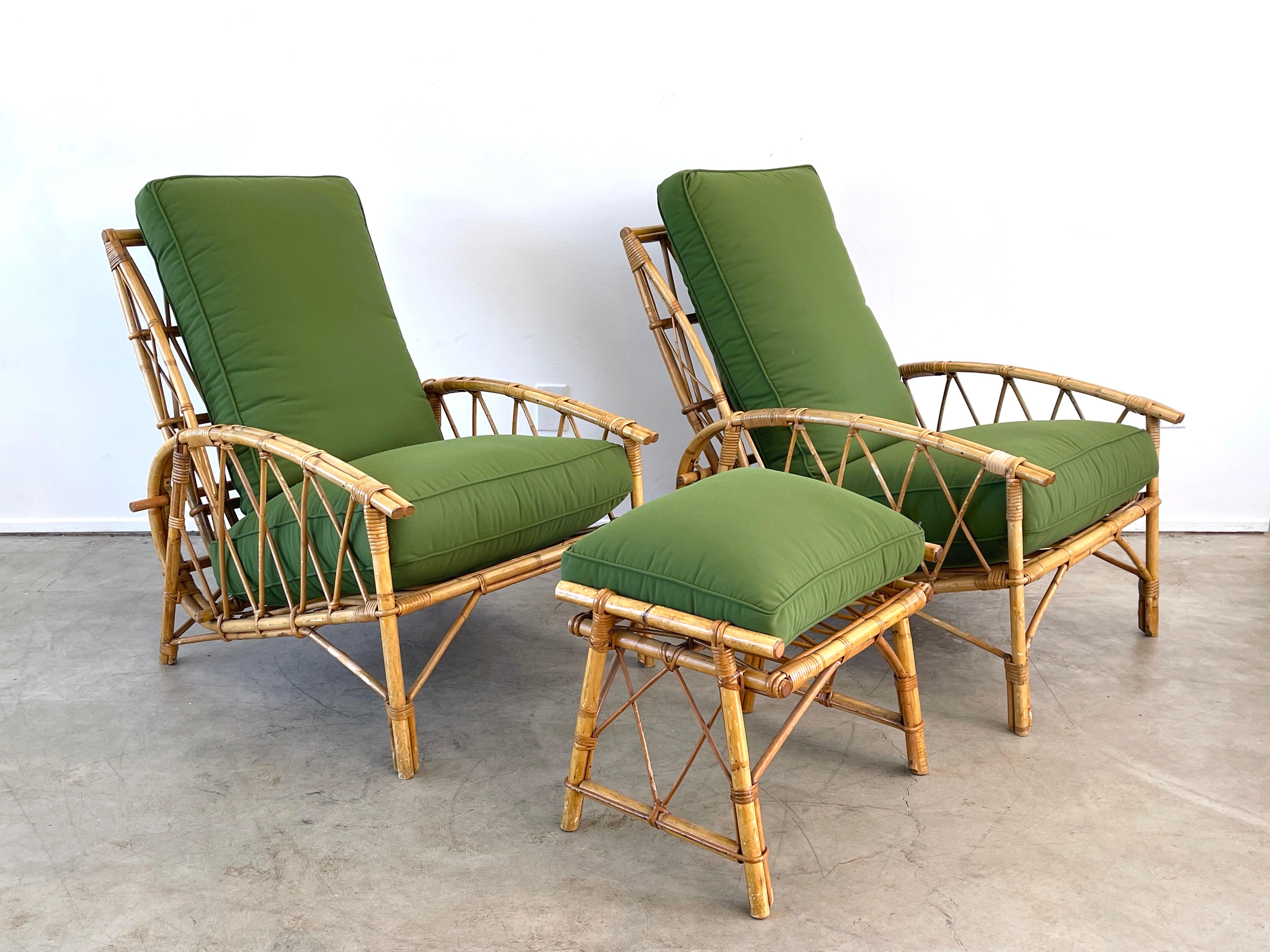 Fantastic pair of Audoux Minet reclining lounge chairs with newly upholstered seat cushions and ottoman. 
Original bamboo bar slides out of brass hardware loop along the back that controls the height of seat back. 
Ottoman 21.50