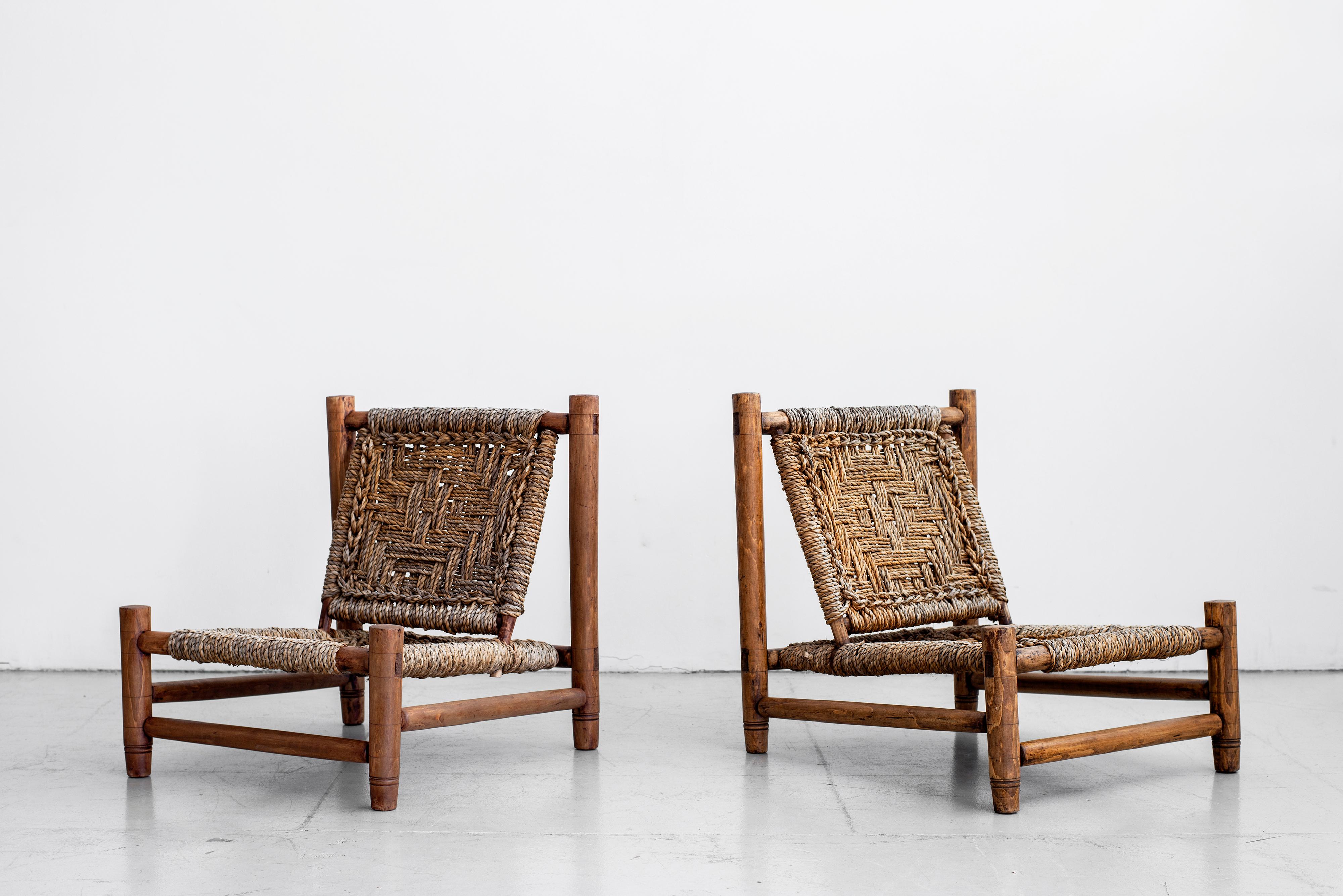 Pair of Adrien Audoux and Frida Minet low lounge chairs. Made of stained beech and abaca rope with beautiful woven design. Nice age and patina throughout. 

 