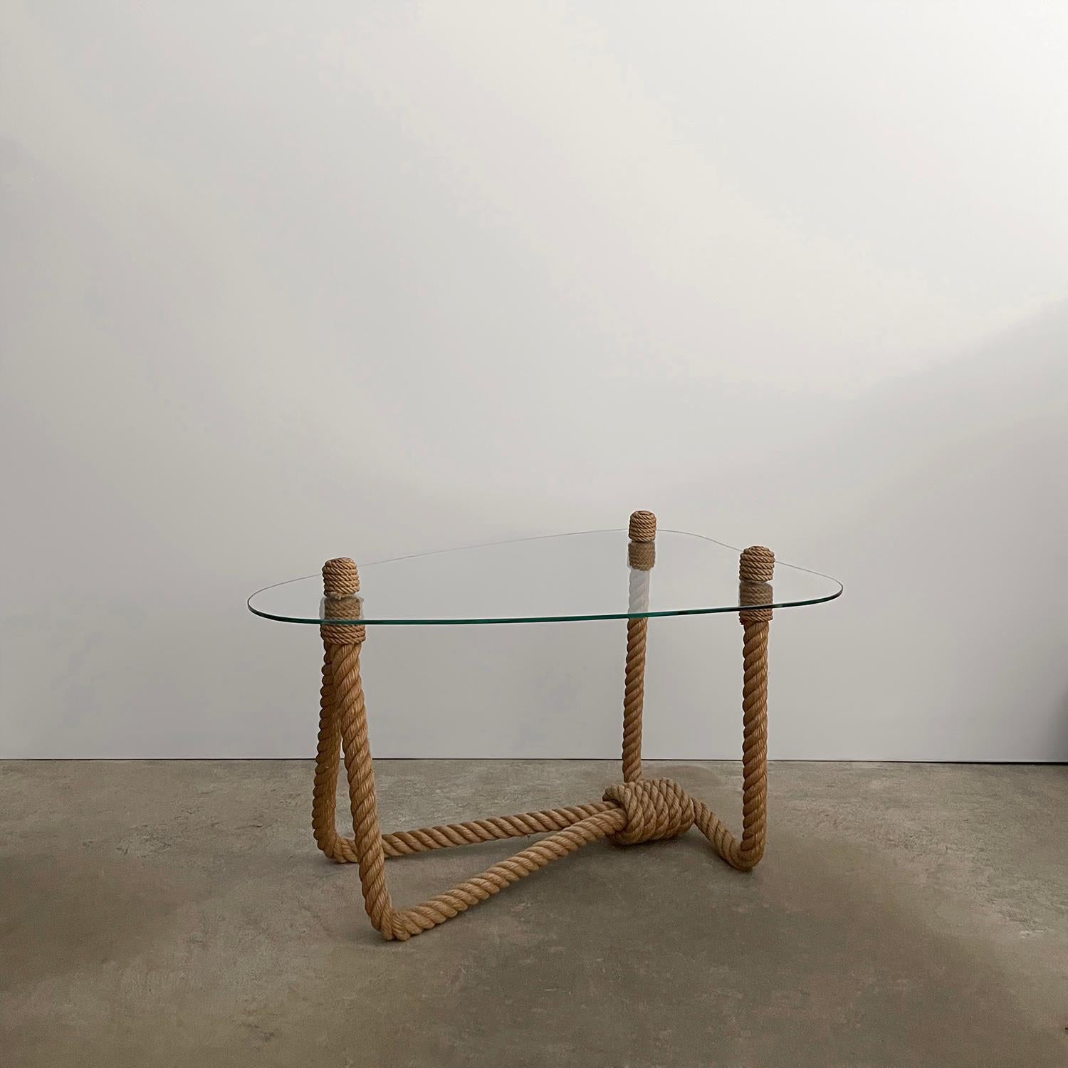 Adrien Audoux and Frida Minet rope & glass coffee table
France, circa 1950’s
Beautifully sculpted rope frame base 
Shield-shaped floating glass delicately rests upon rope posts finished with coiled rope caps
Original glass has light surface