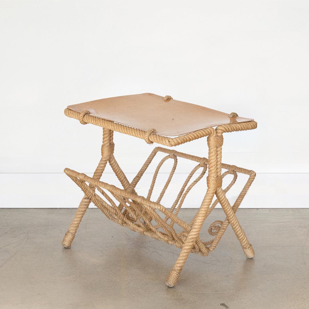 Incredible vintage rope table and magazine rack by Adrien Audoux and Frida Minet from France, 1960's. Table has original tan colored mesh resin top and original rope frame and legs. Rope magazine holder sits below table with great curved rope