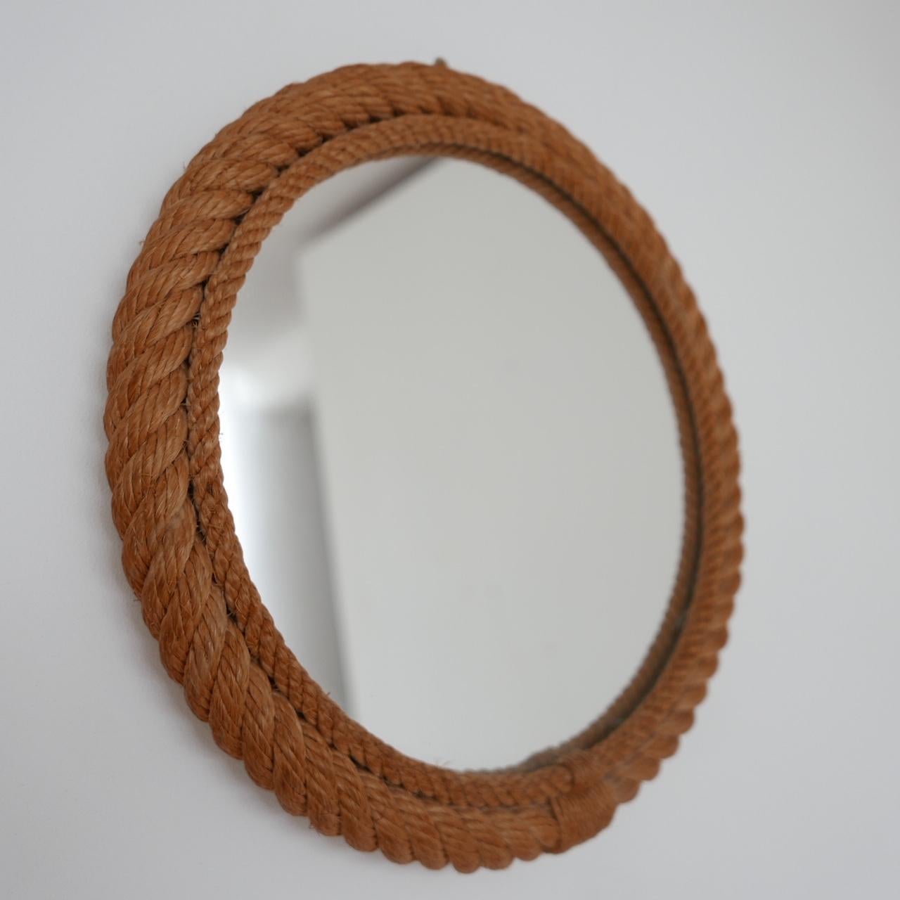 A ropecord mirror attributed to Audoux-Minet,

France, c1960s. 

A mid to smaller sized model. 

Condition: generally good condition with some scuffs and marks commensurate with age. 

Dimensions: 30 diameter x 3 depth in cm. 

Delivery: POA.

 
