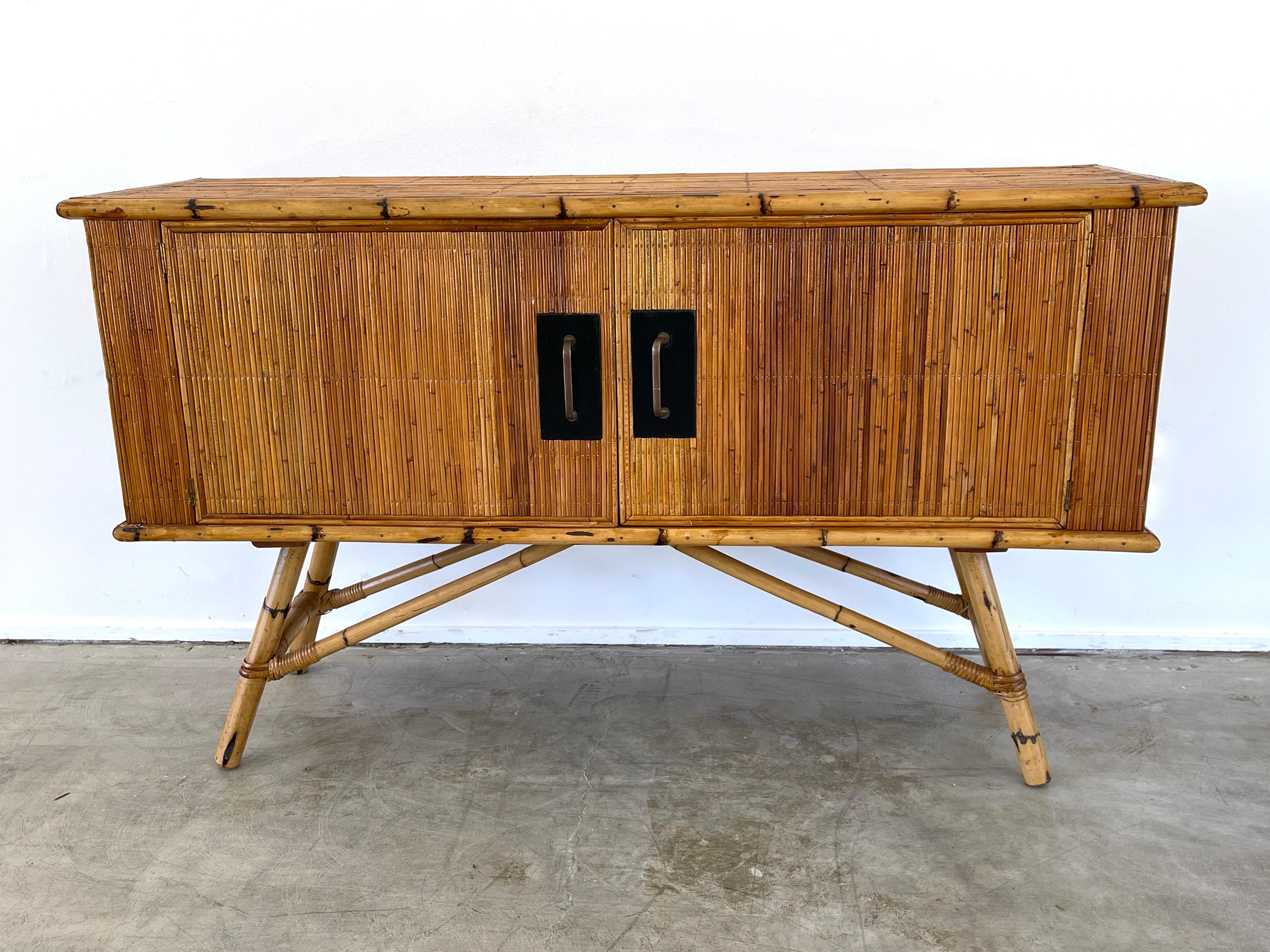 Audoux Minet bamboo cabinet, France circa 1970's
2 open cabinet doors reveal shelving 
Wonderful patina'd hardware 