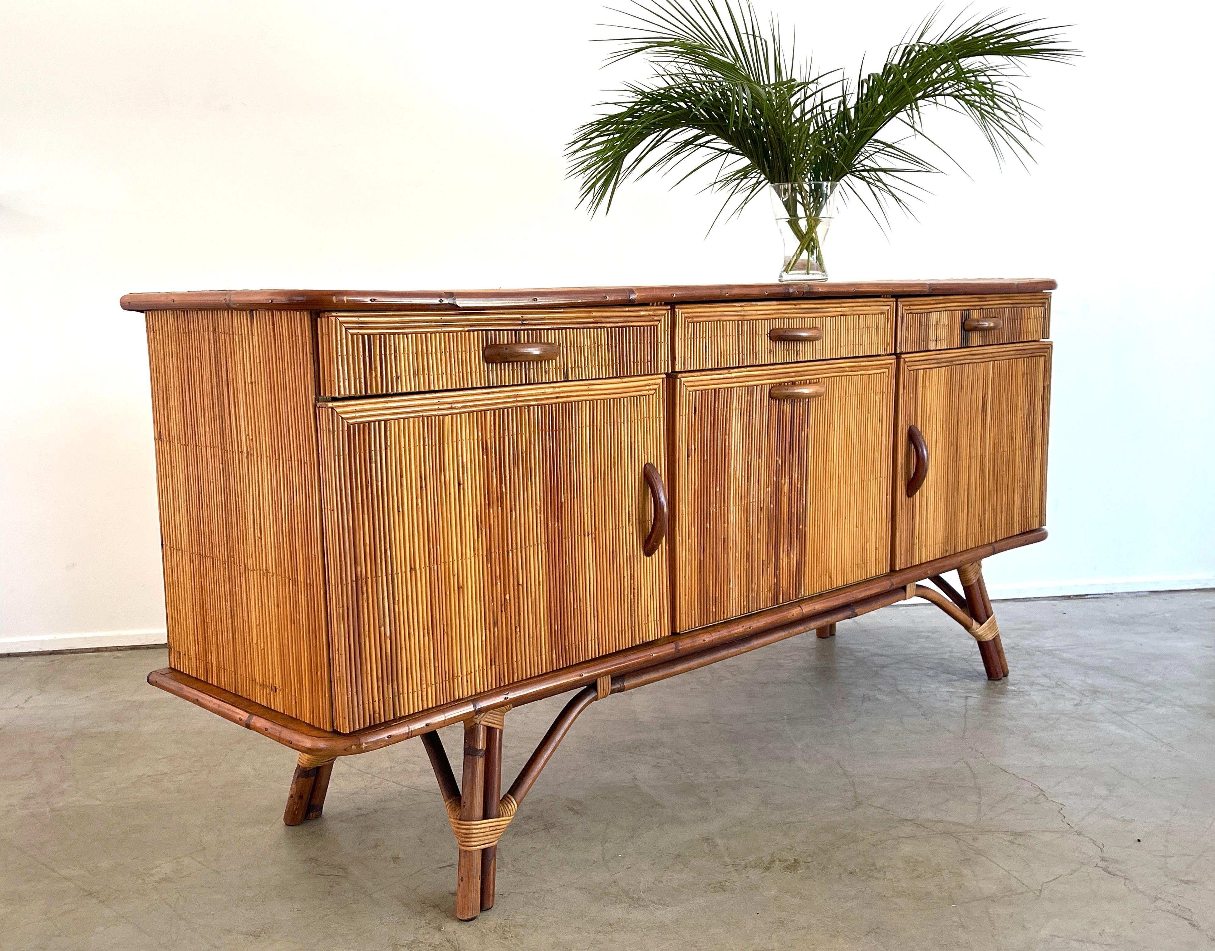Beautiful bamboo sideboard by Audoux Minet with pencil reed bamboo throughout and wood handles. 
Sophisticated and chic design.
