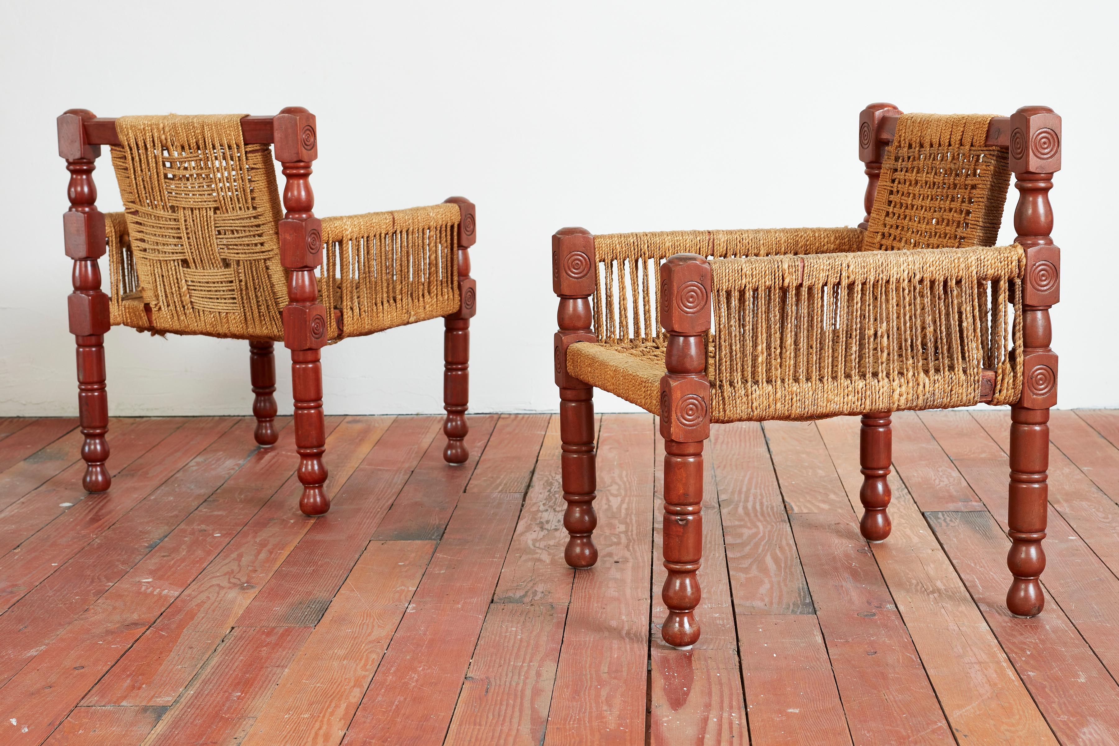 Great pair of chairs in the style of Audoux Minet
Carved signature frames with woven rope back and seat
Matching ottomans sold separately.