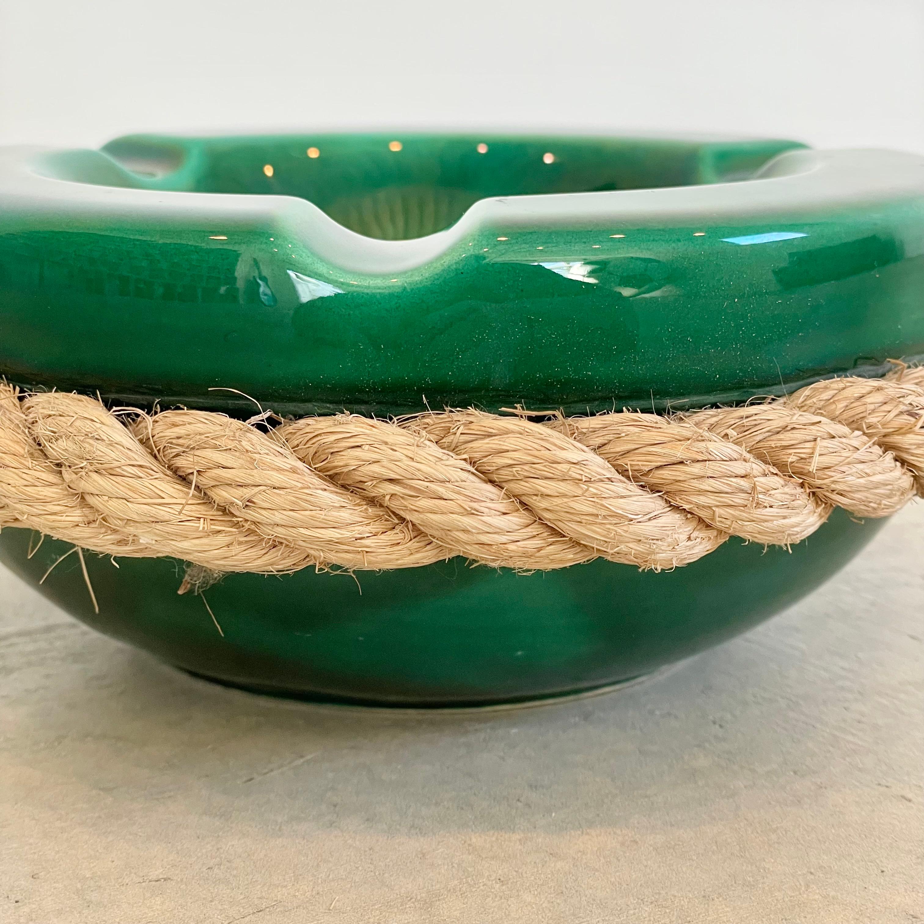 Large green ceramic ashtray with thick rope detailing in the style of French-Swiss husband-and-wife duo Adrien Audoux and Frida Minet, circa 1970.

Beautiful green ceramic with varying hues make up the bulk of the ashtray, whilst a single piece of