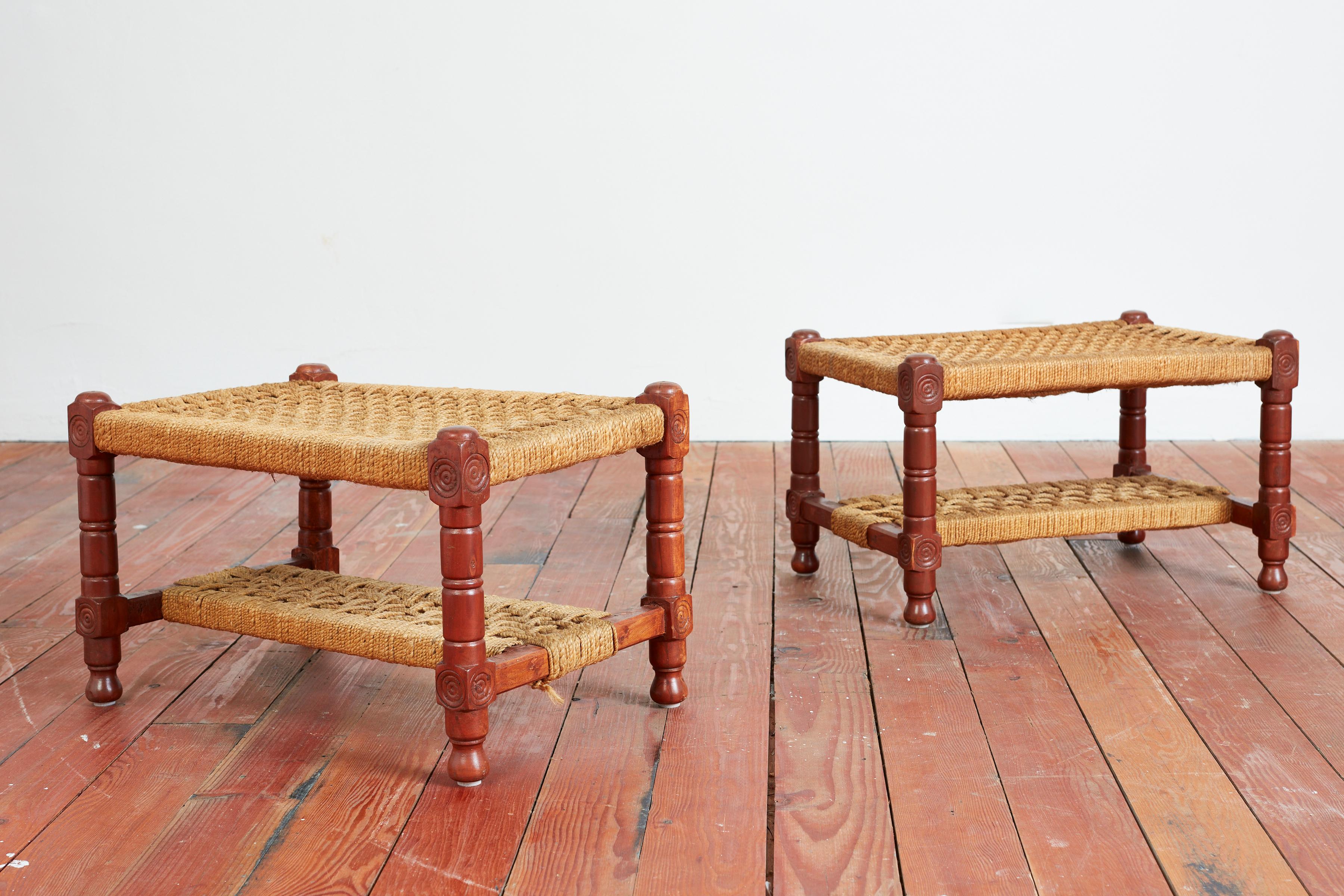 Large scale pair of ottomans / stools in the style of Audoux Minet 
Carved oak frames with woven rope seats.