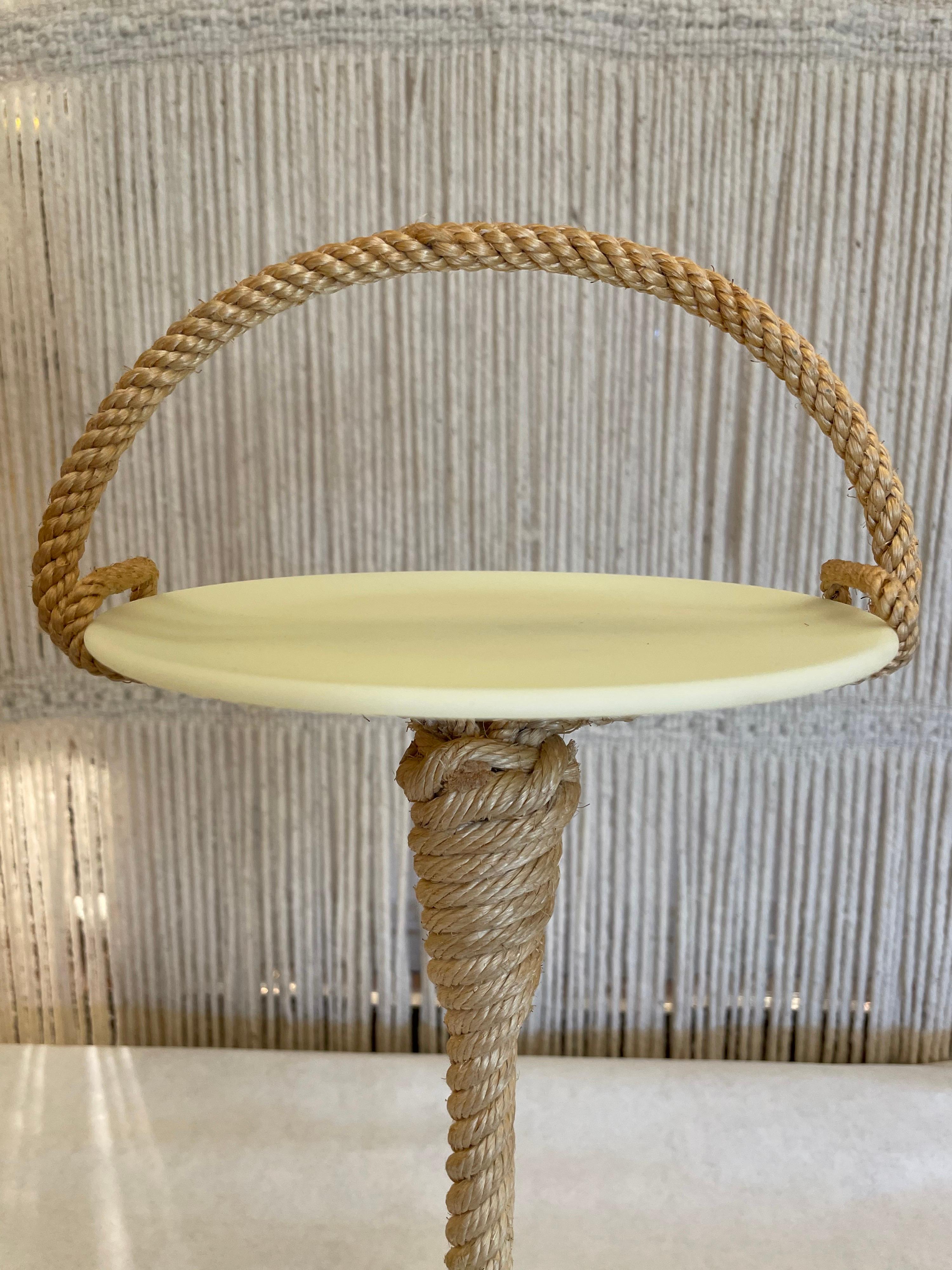 This exquisitely crafted natural rope clad petite side table with an opaline plateau (7.5 inches diameter of plate). Tightly wrapped natural jute rope over this petite side table holding an opaline plate. A very small yet stunning piece.