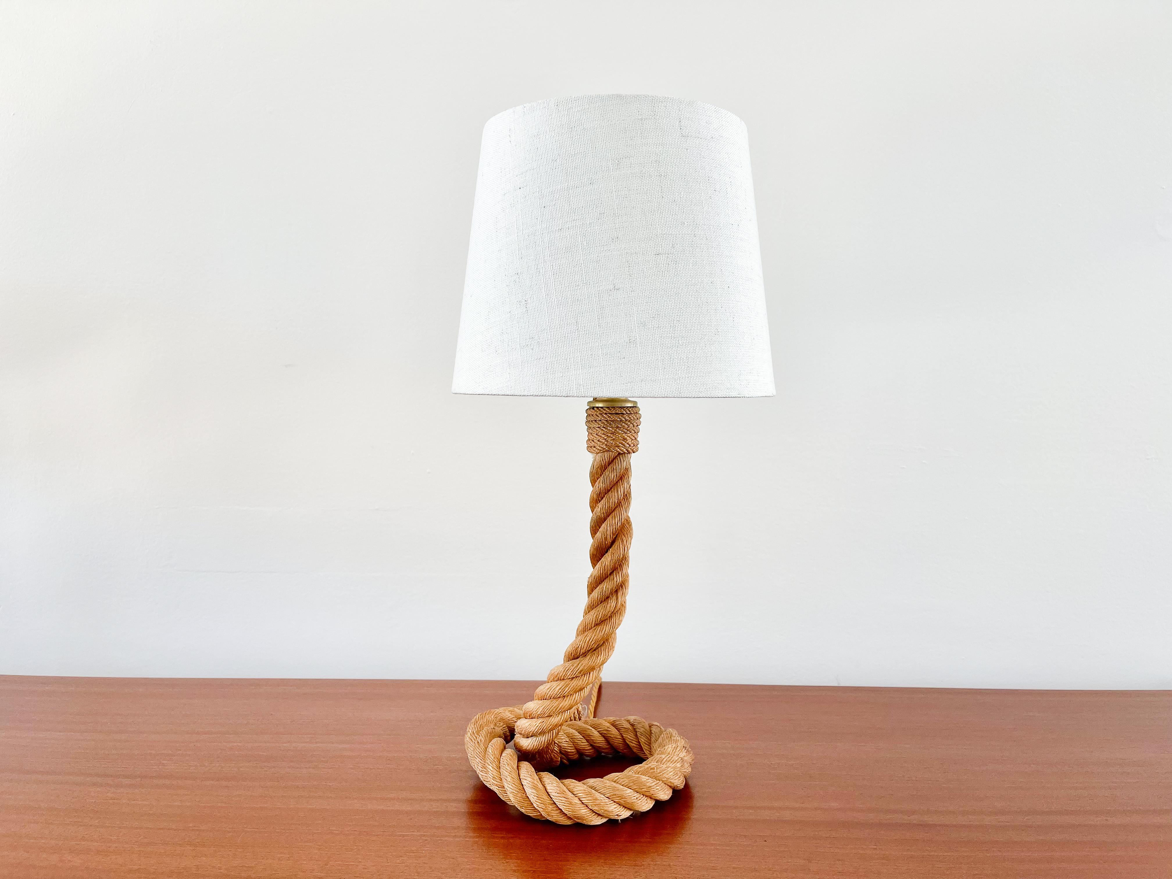 Signature Audoux Minet style table lamp with thick coiled rope and new linen shade. 
Restored and rewired.