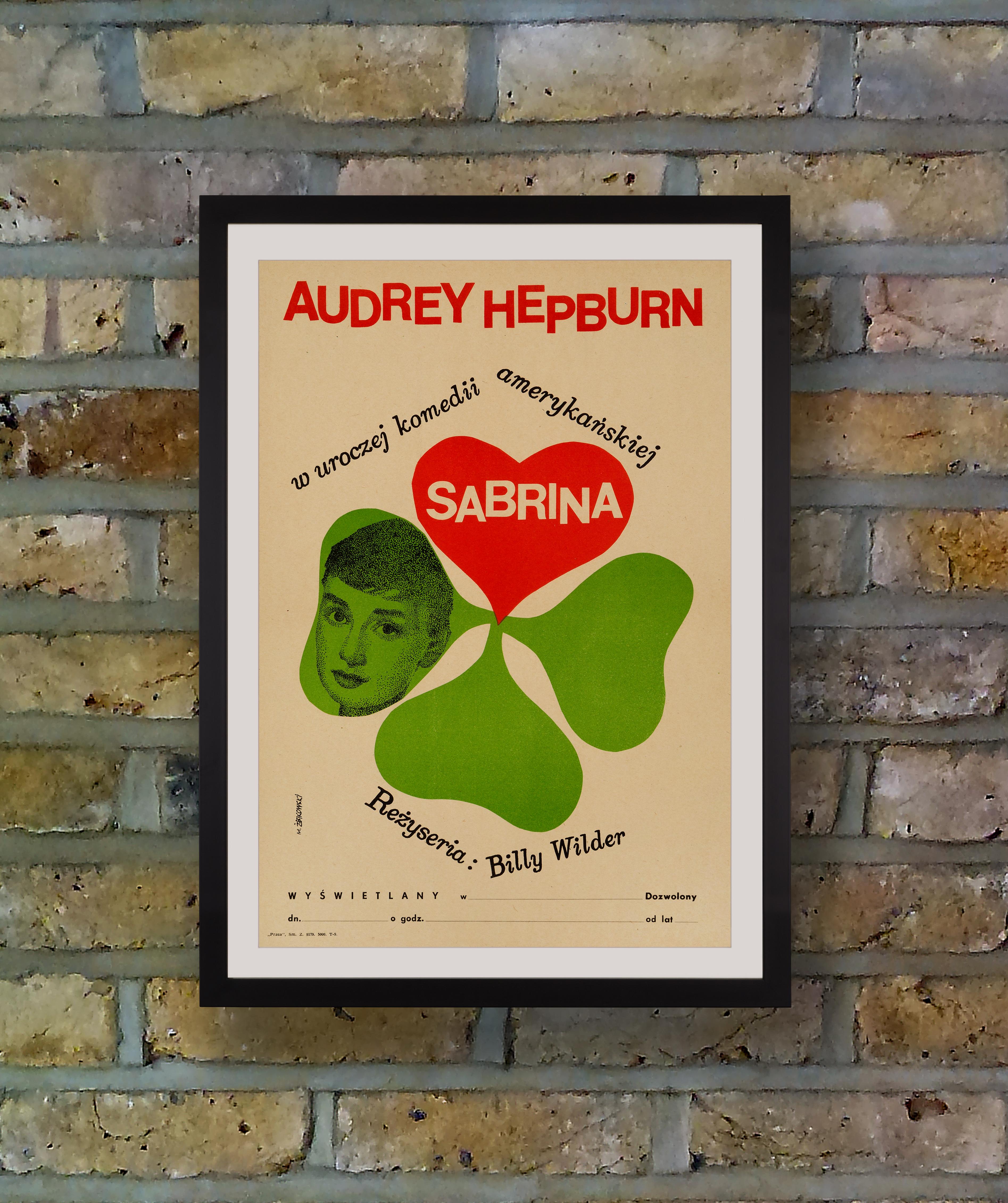 Artist Maciej Zbikowski pictured a portrait of Audrey Hepburn within the petal of a lucky four leaf clover on this rare and quirky mini poster for the first Polish release of 
