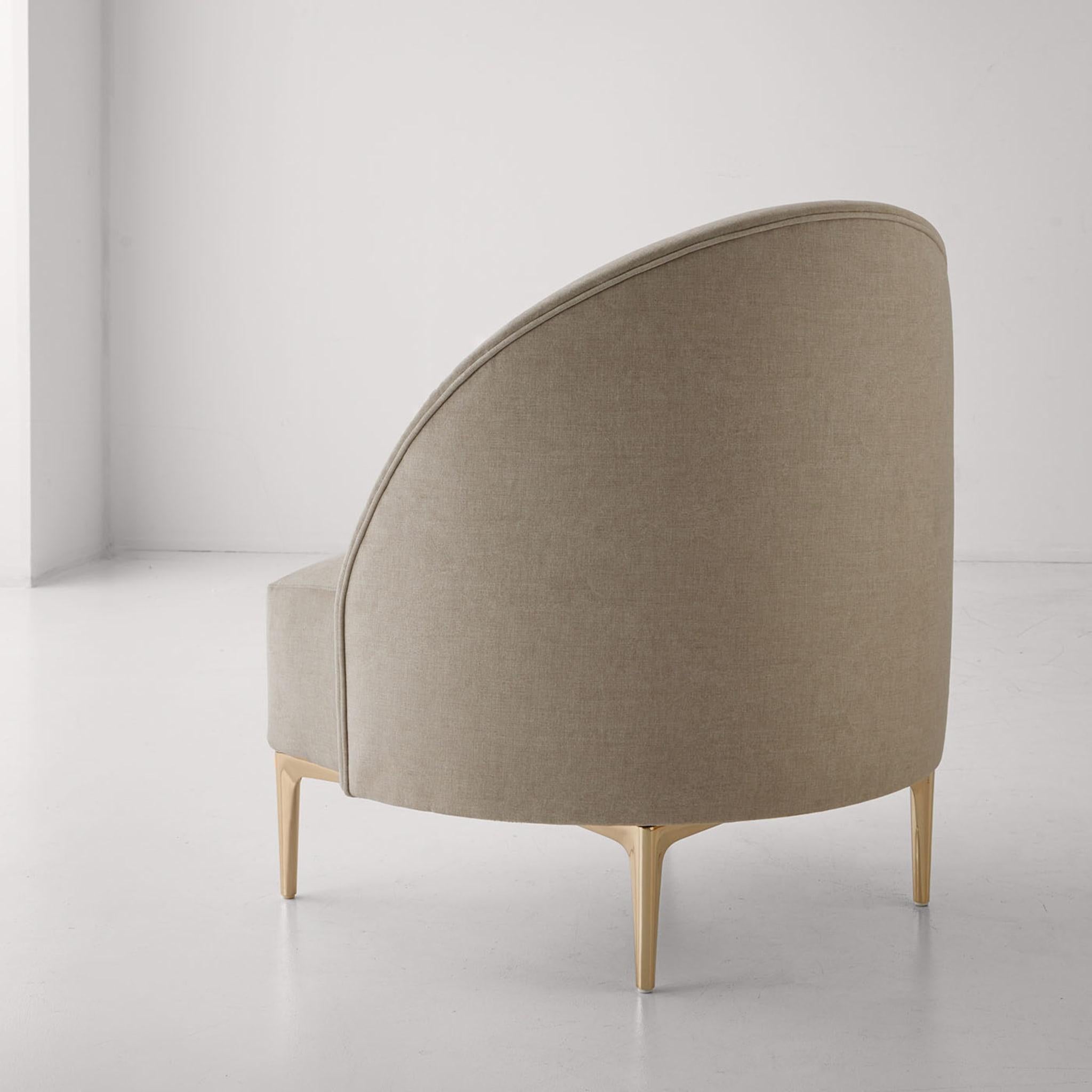 Audrie lounge chair upholstered in velvet and gold metal legs.