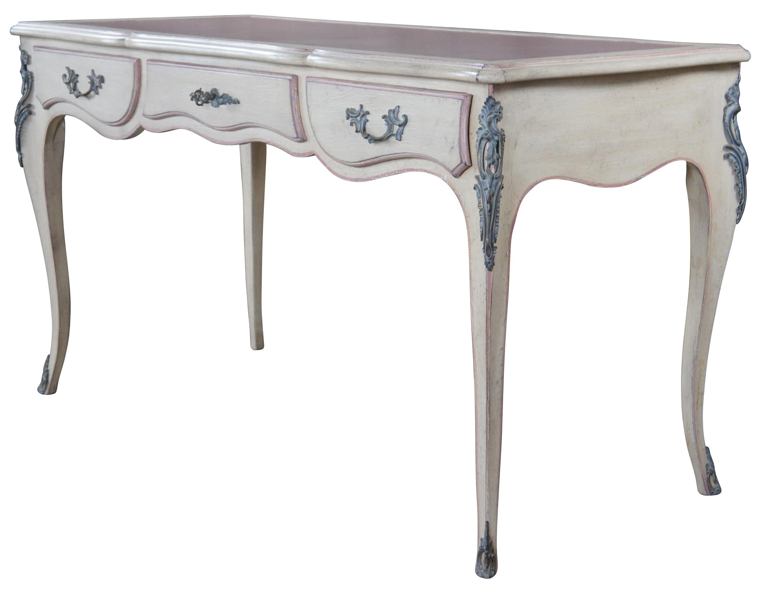 Custom ordered French Provincial Bureau Plat or lady's writing desk by Auffray & Company. Features a shaped serpentine top with pink tooled leather, a frieze fitted with three drawers and ornate bronze ormolu mounts, raised over cabriole legs. Made