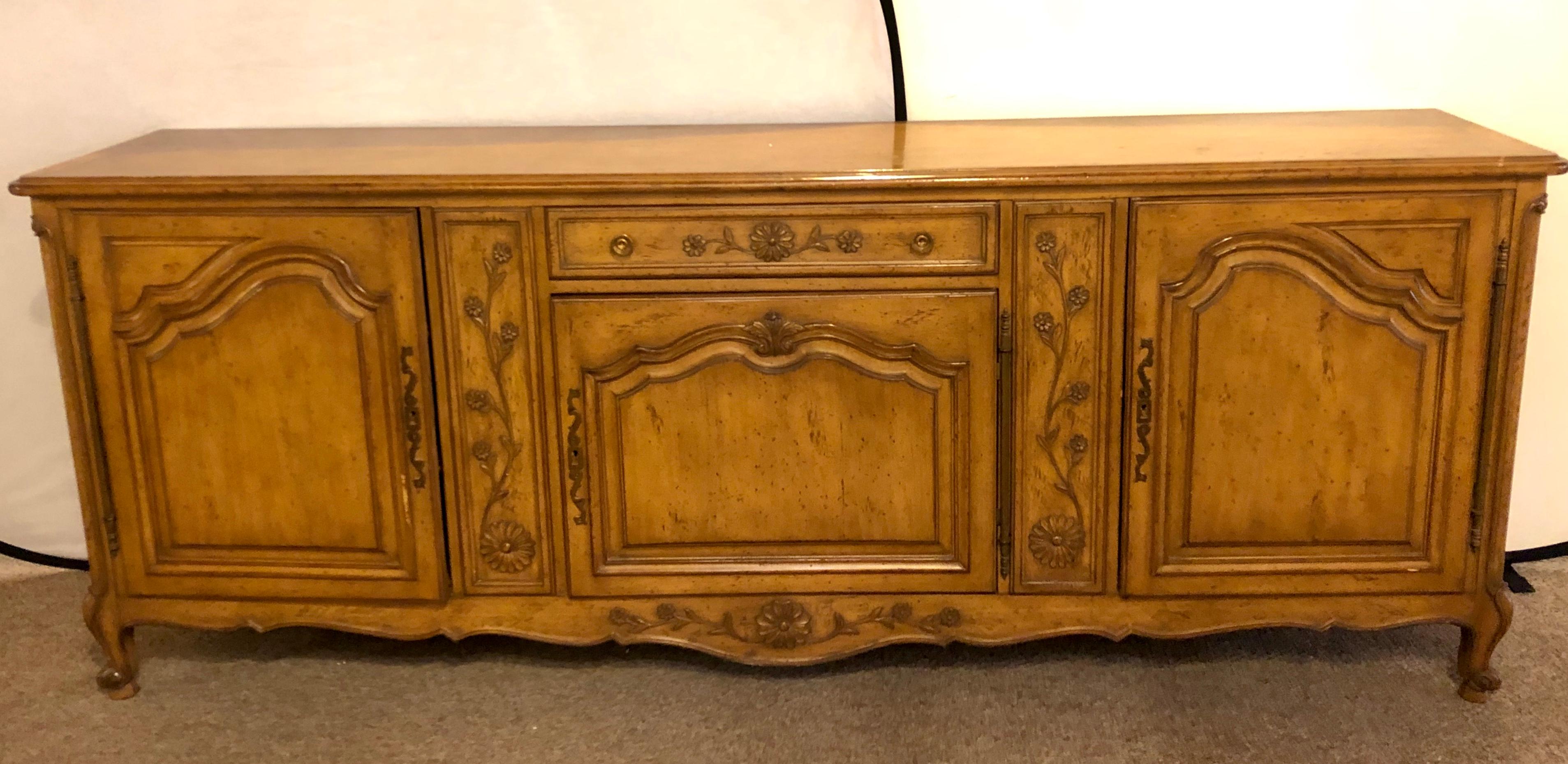 Auffray & Company, 18th century style Country French sideboard / buffet. This spectacular impressive and large sideboard has a center door which leads to three interior drawers the lower two with fitted burgundy velour fittings to hold your