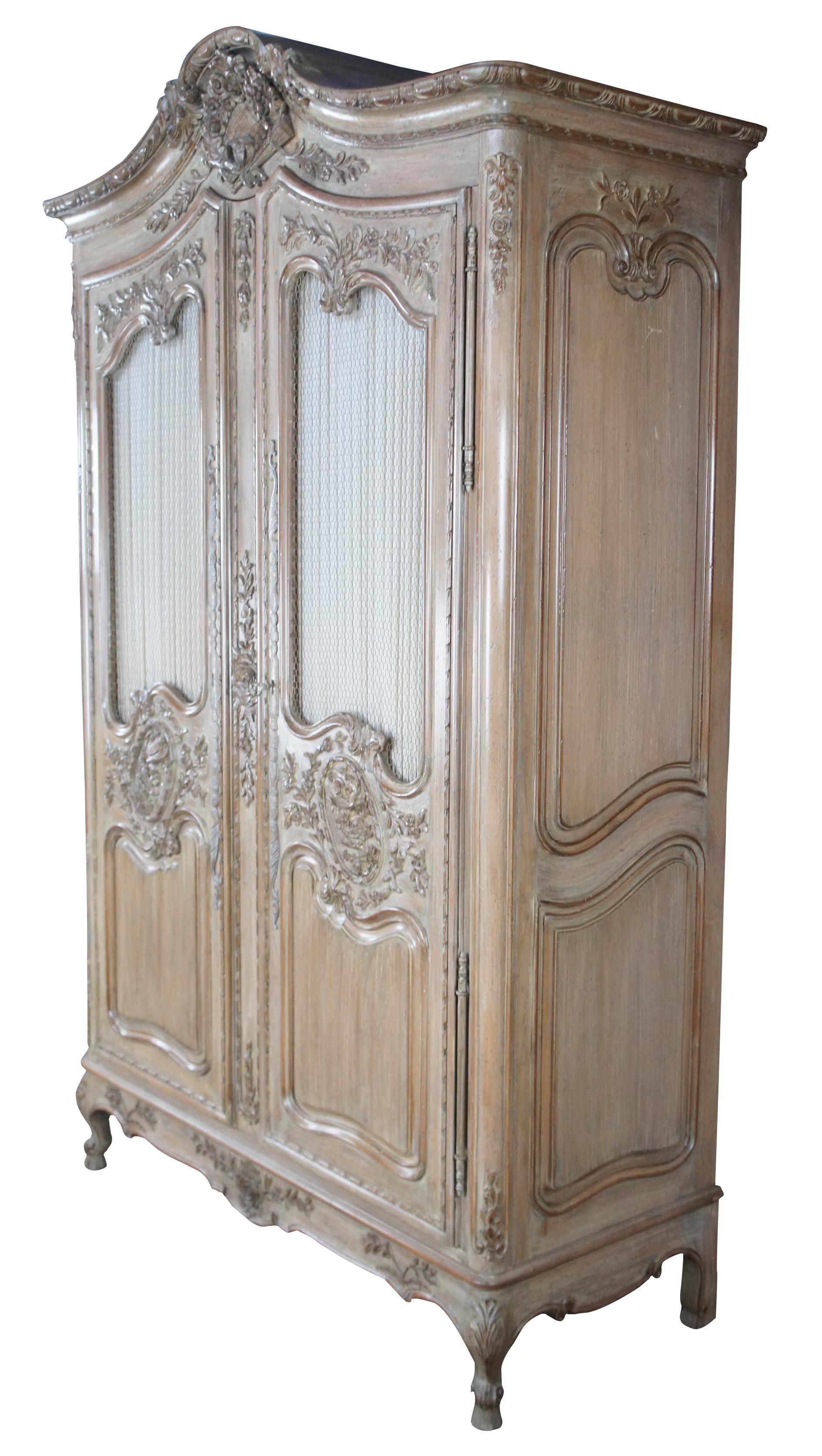Vintage Auffray & Co fine French furniture armoire. Featuring a blend of Country French and Provincial styling with Neoclassical accents, chicken wire drape doors and cabriole legs. Opens to TV compartment with area for components and six additional