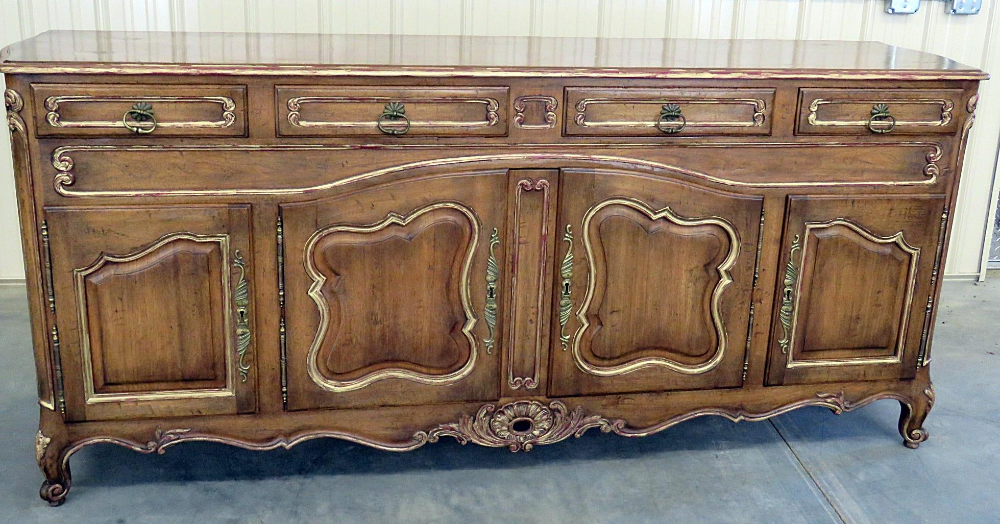 Attributed to Auffray because of the outstanding quality. This Country French distressed finished sideboard has 4 drawers over 4 doors containing 3 drawers and 2 shelves.
