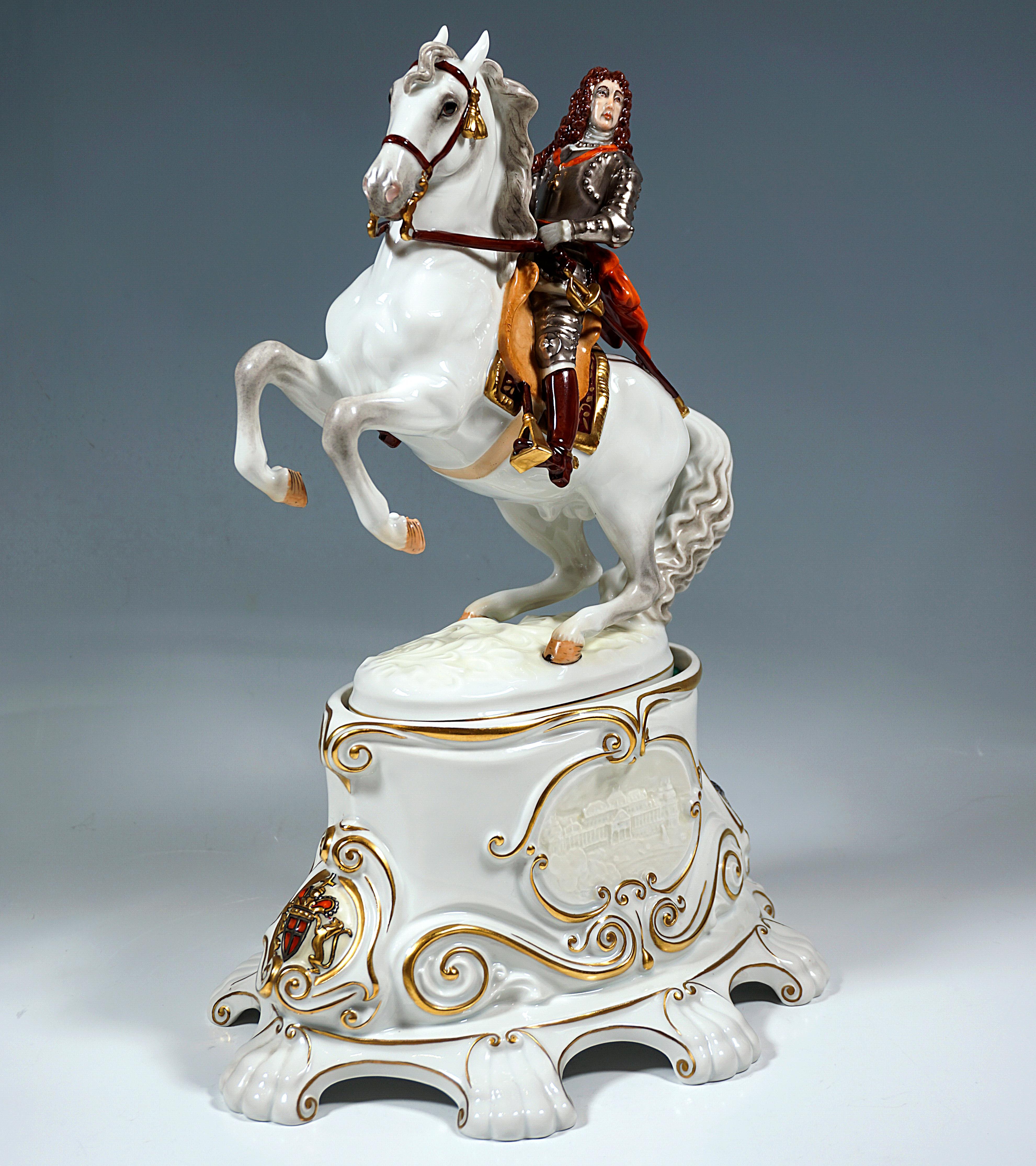 Depiction of the commander Prince Eugene of Savoy with a baroque curly wig and in armor on horseback, holding the field marshal's baton in his right hand, the horse performing the classic riding figure of the 'Levade' and based on an oval plinth, as