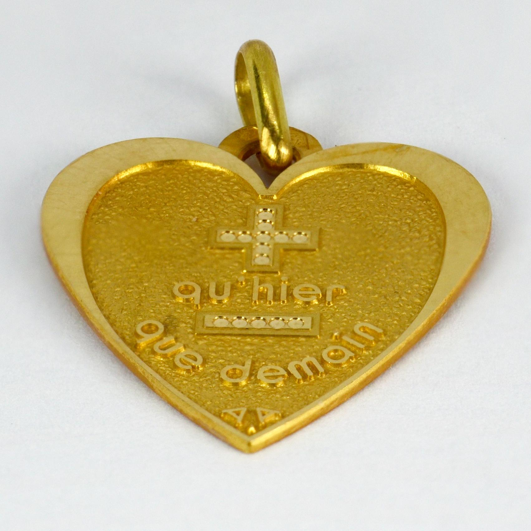 A French 18 karat (18K) yellow gold heart shaped love charm pendant with a rebus spelling out 