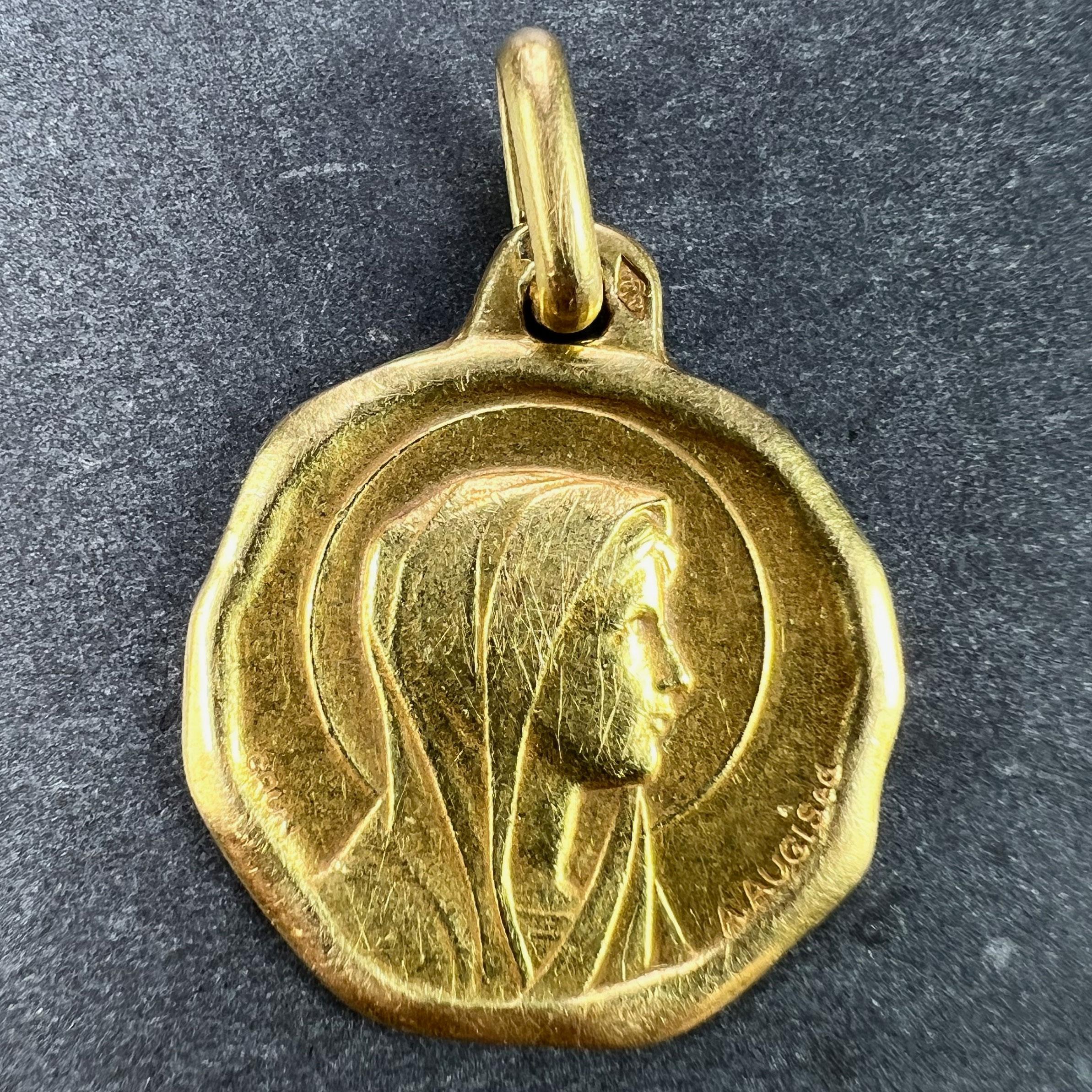 A French 18 karat (18K) yellow gold charm pendant or medal designed by Grun for Augis depicting the Virgin Mary. Stamped with the eagle's head for French manufacture, Augis' makers mark, and signed A. Augis and Grun.

Dimensions: 2.2 x 1.9 x 0.1 cm